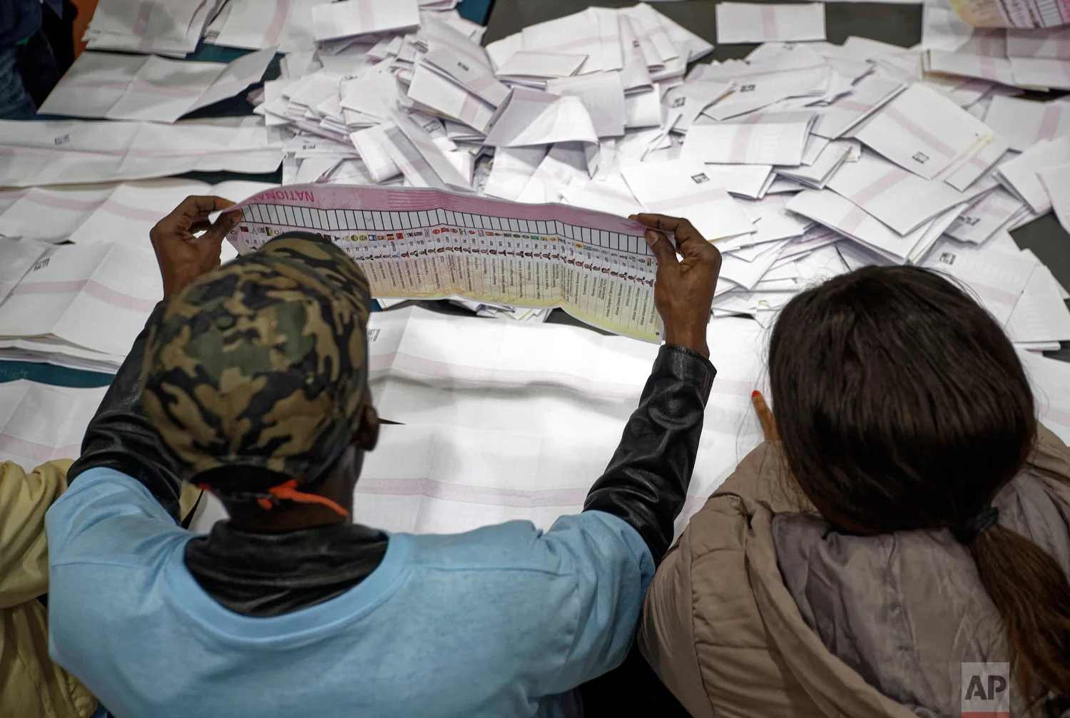 Electoral workers count ballots in view of party agents after the close of polls at the Parkhurst Primary School in Johannesburg, South Africa, May 8, 2019. (AP Photo/Ben Curtis)