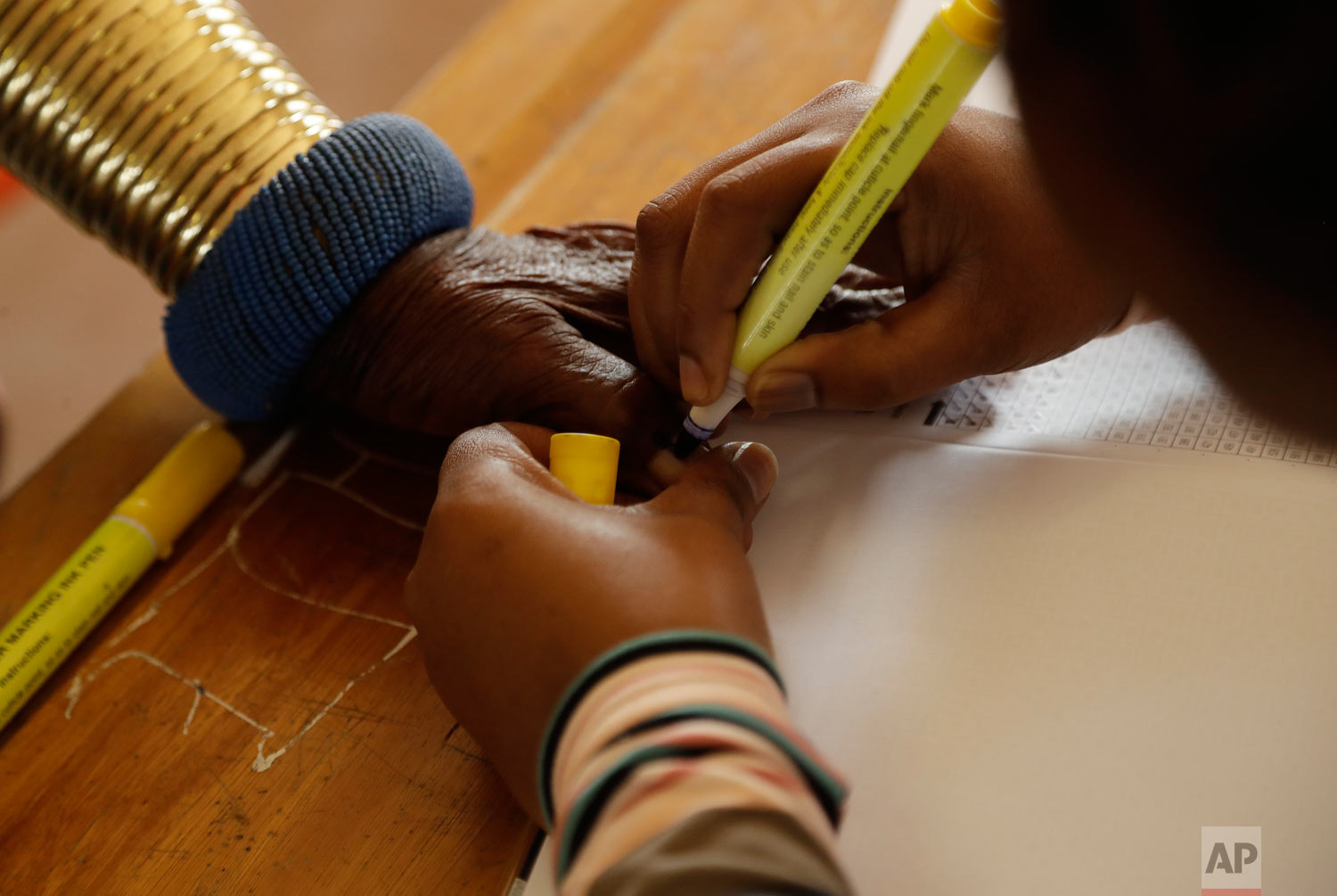 Esther Mahlangu has her thumb ink-marked before casting her vote at a polling station at KwaMhlanga in Mpumalanga, South Africa, May 8, 2019. (AP Photo/Themba Hadebe)