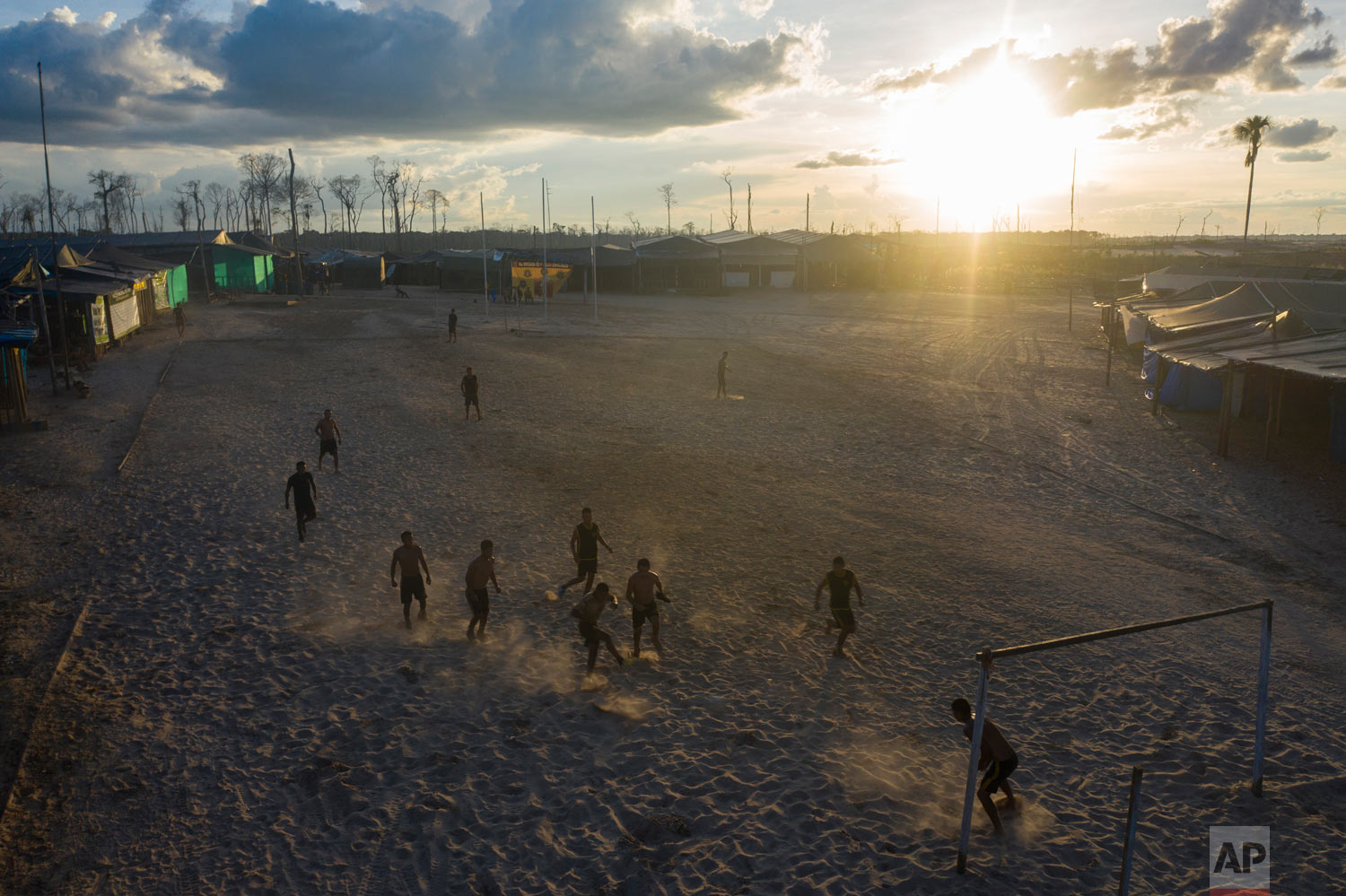 "Operation Mercury" soldiers play soccer at the Balata police and military base, March 31, 2019, in Peru's Tambopata province. As night falls, they play cards, watch television and call family from their remote outpost. (AP Photo/Rodrigo Abd)