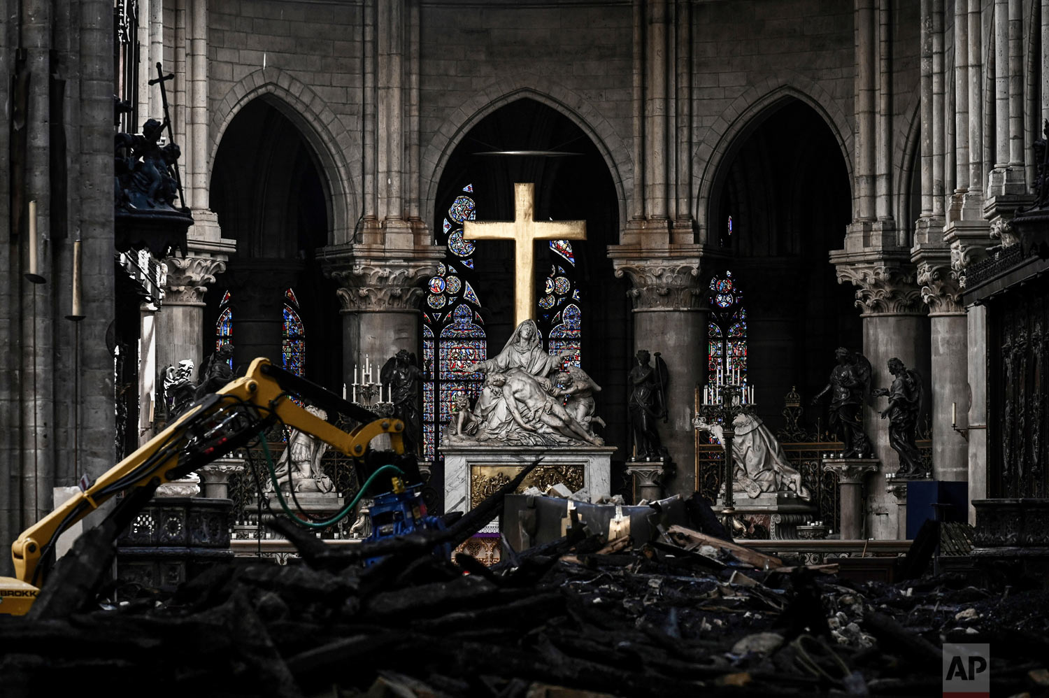  Rubble lies below the Pieta sculpture and a cross inside the Notre Dame de Paris cathedral on Wednesday May 15, 2019 in Paris. (Philippe Lopez/Pool via AP) 