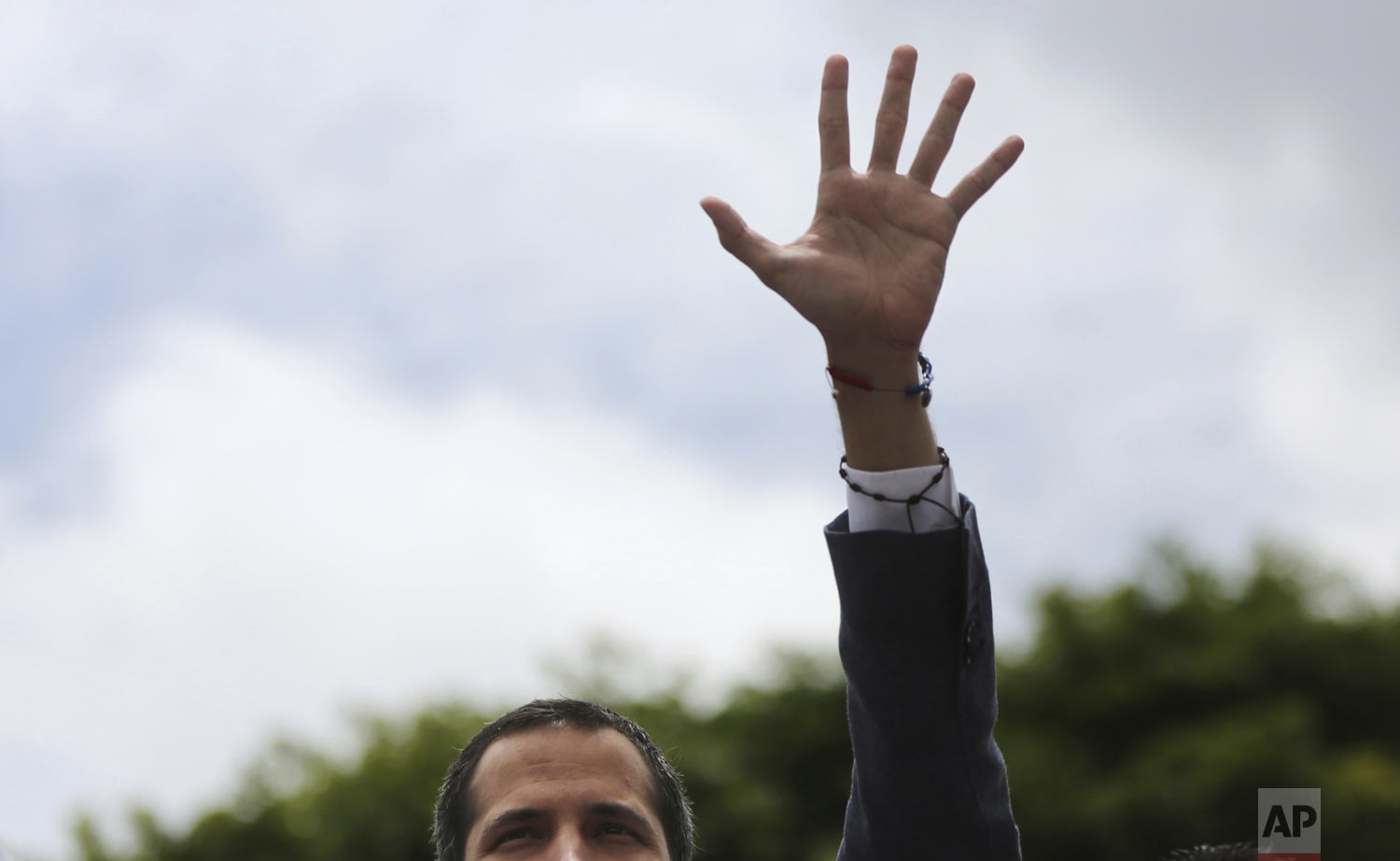  Opposition leader Juan Guaidó greets supporters as he arrives to lead a rally in Caracas, Venezuela, Saturday, May 11, 2019. Guaidó has called for nationwide marches protesting the Maduro government, demanding new elections and the release of jailed