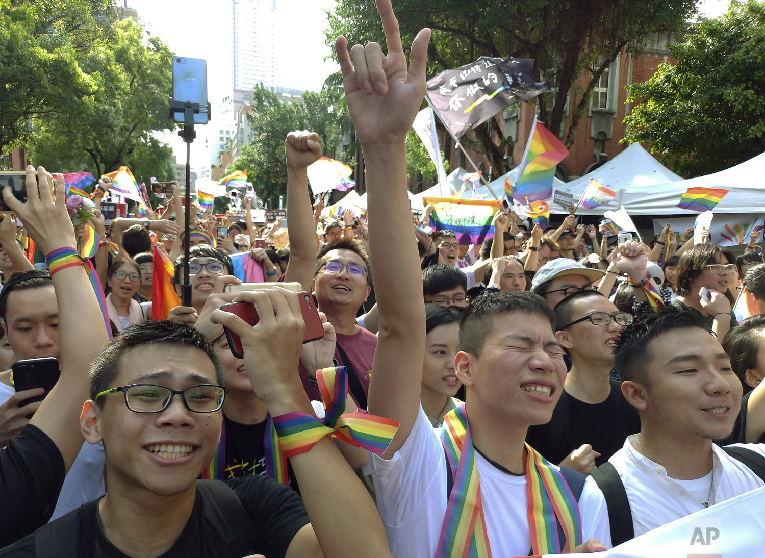  People cheer outside the Legislative Yuan in Taipei, Taiwan on Friday, May 17, 2019 after the passage of a law allowing same-sex marriage - a first for Asia. The vote Friday allows same-sex couples full legal marriage rights, including in areas such