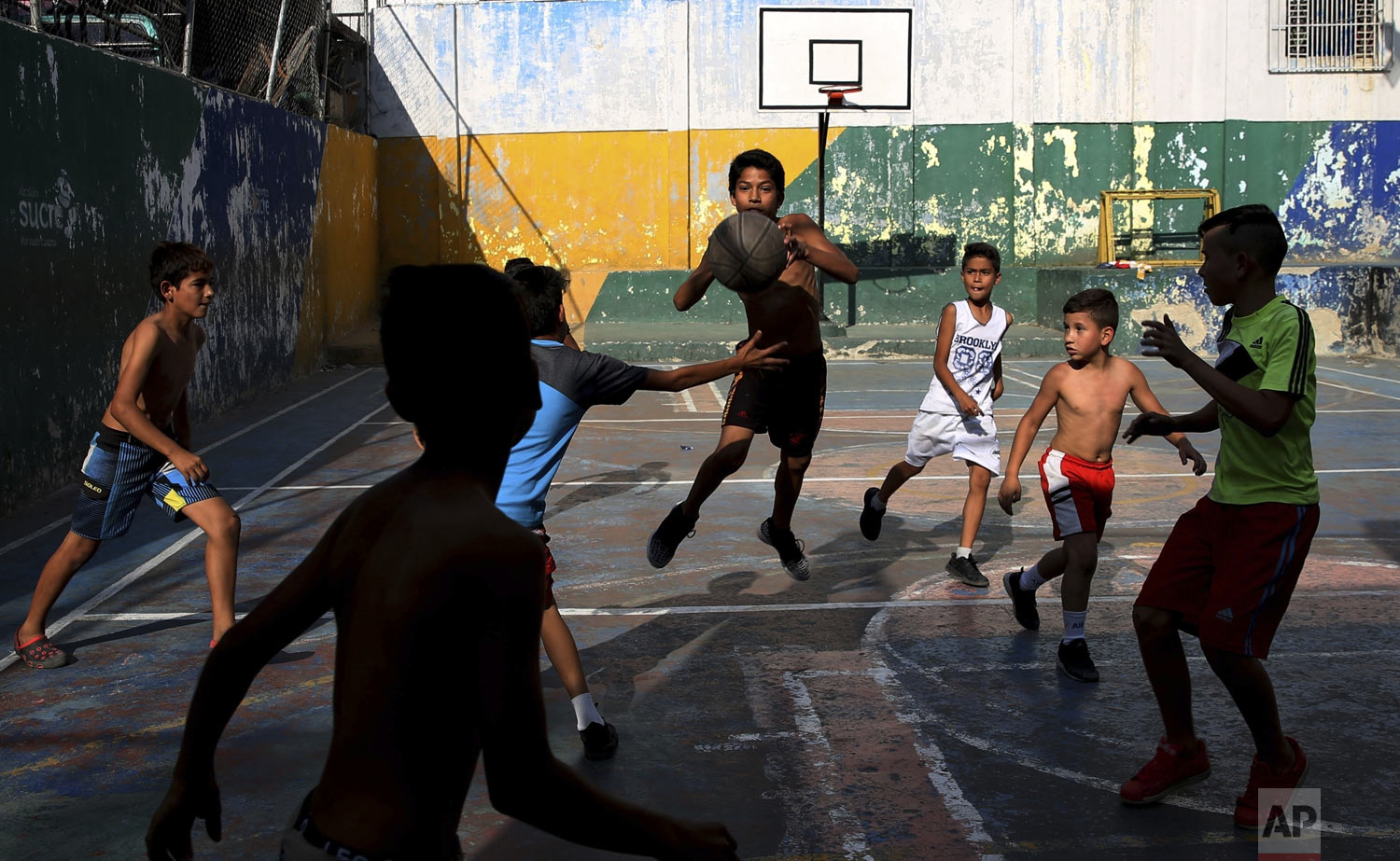  A group of boys play basketball at the Petare shantytown, in Caracas, Venezuela, Thursday, May 16, 2019. (AP Photo/Martin Mejia) 