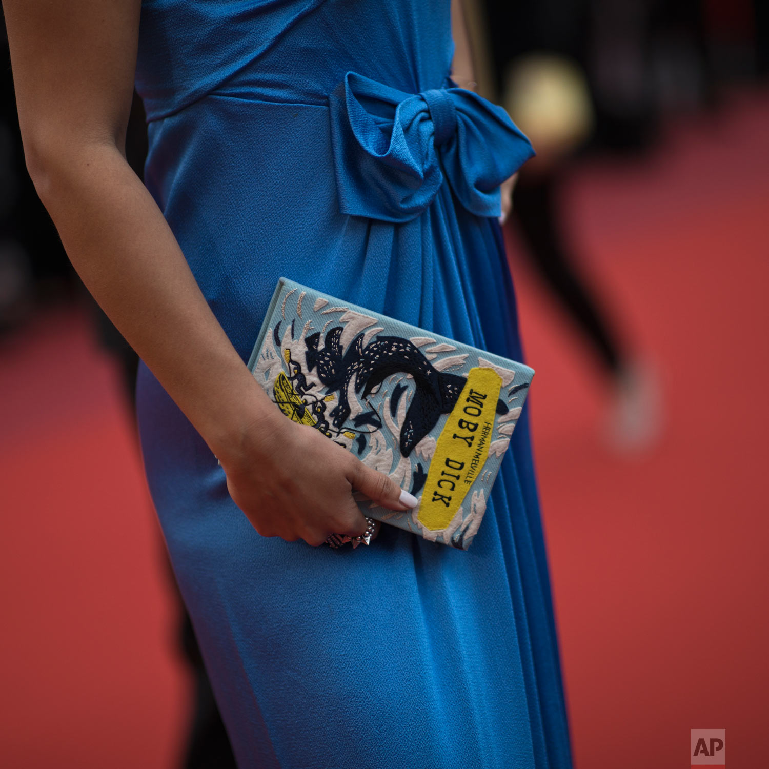A woman poses for photographers upon arrival at the premiere of the film 'A Hidden Life' at the 72nd international film festival, Cannes, southern France, May 19, 2019. (AP Photo/Petros Giannakouris)