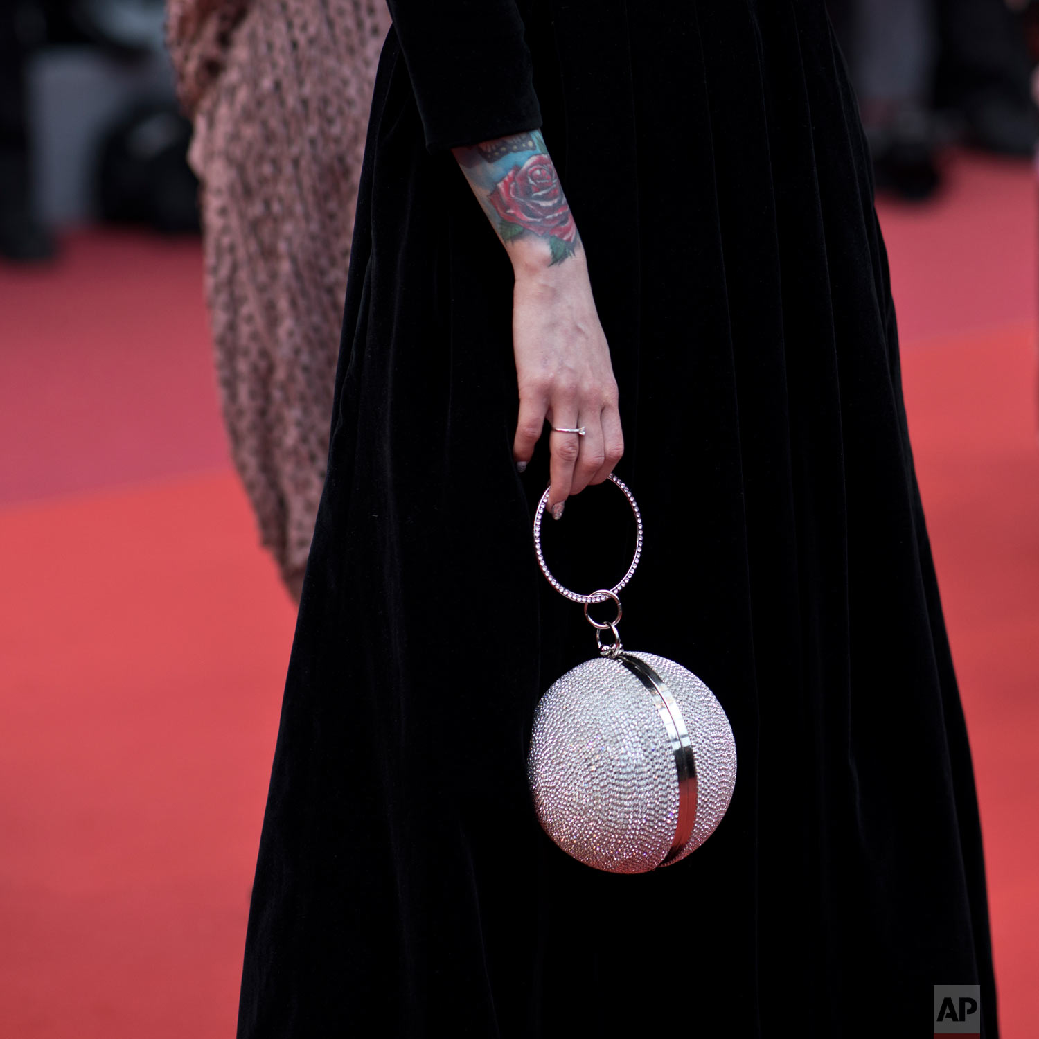 A woman poses for photographers upon arrival at the premiere of the film 'A Hidden Life' at the 72nd international film festival, Cannes, southern France, May 19, 2019. (AP Photo/Petros Giannakouris)