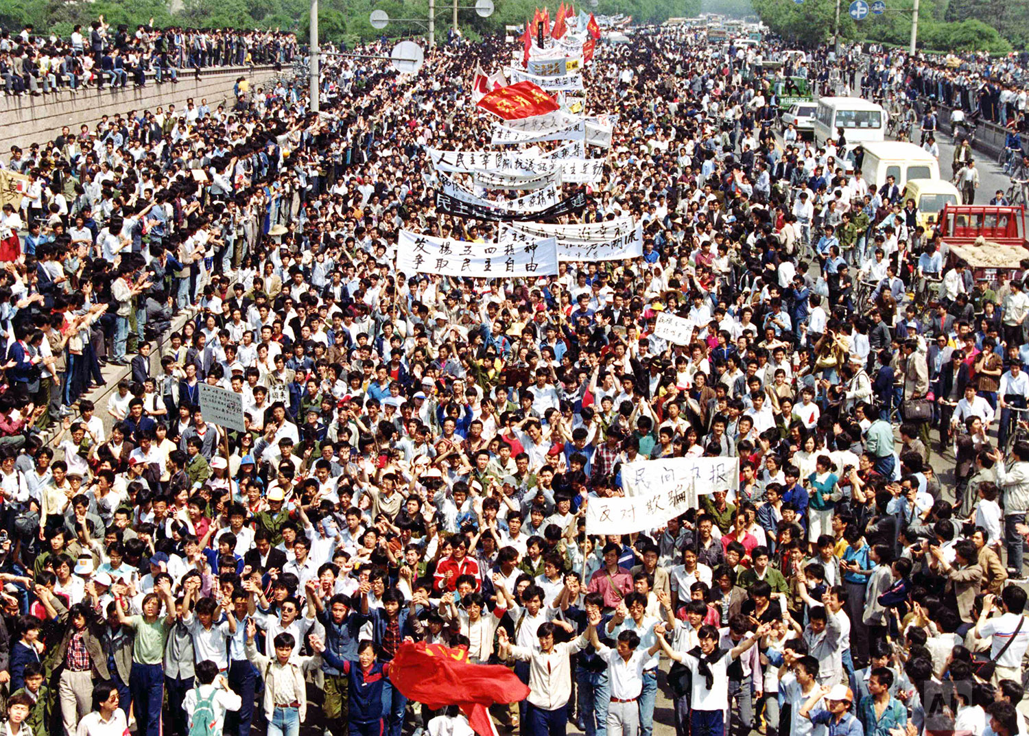  More than seven thousand students from local colleges and universities march to Tiananmen Square, Beijing, May 4, 1989, to demonstrate for government reform. (AP Photo/Mikami)  