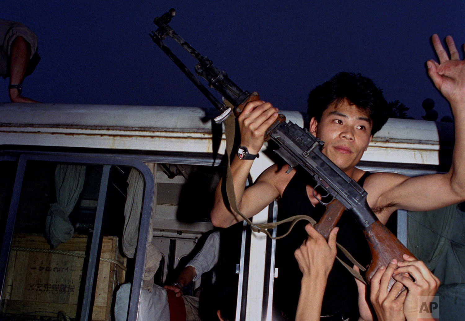  An anti-government protester in Beijing holds a rifle in a bus window, June 3, 1989. Pro-democracy protesters had been occupying Tiananmen Square for weeks; hundreds died that night and the following morning in clashes with Chinese troops. (AP Photo