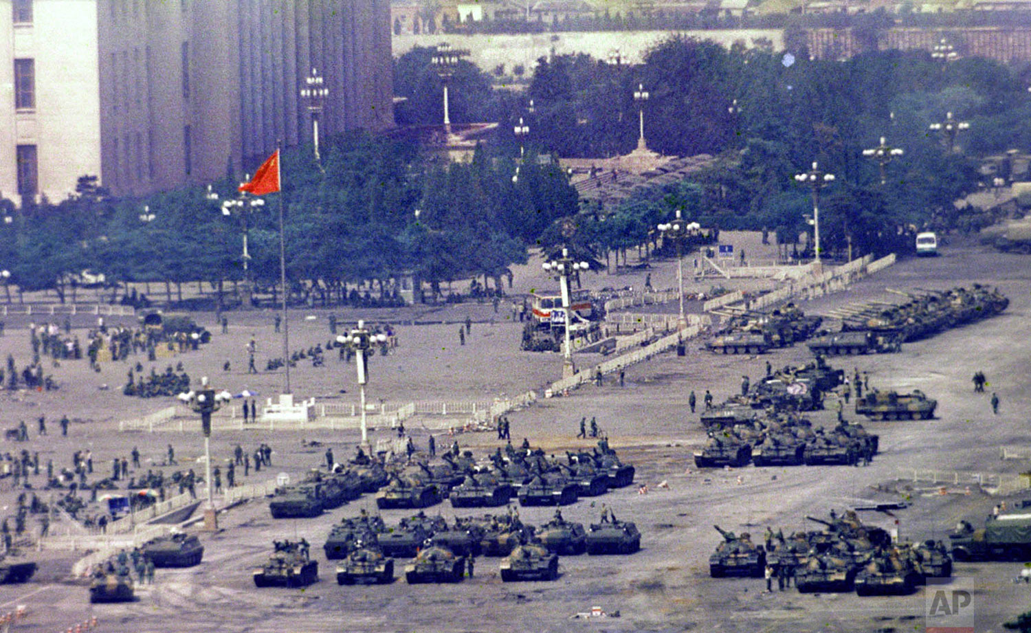  Chinese troops and tanks gather in Beijing, June 5, 1989, one day after the military crackdown that ended a seven week pro-democracy demonstration on Tiananmen Square. Hundreds were killed in the early morning hours of June 4. (AP Photo/Jeff Widener