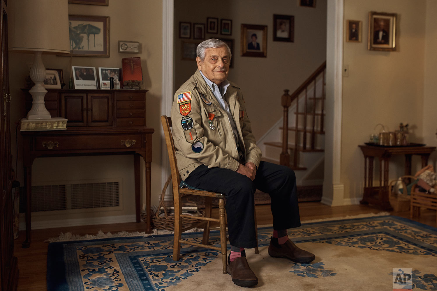 World War II U.S. veteran Frank DeVita, who took part in the D-Day battle poses for a picture at his home in Bridgewater, N.J., May 14, 2019. This June he’ll make his 12th trip back to Normandy. He likes to bring people with him so they’ll know what happened there. (AP Photo/Andres Kudacki)