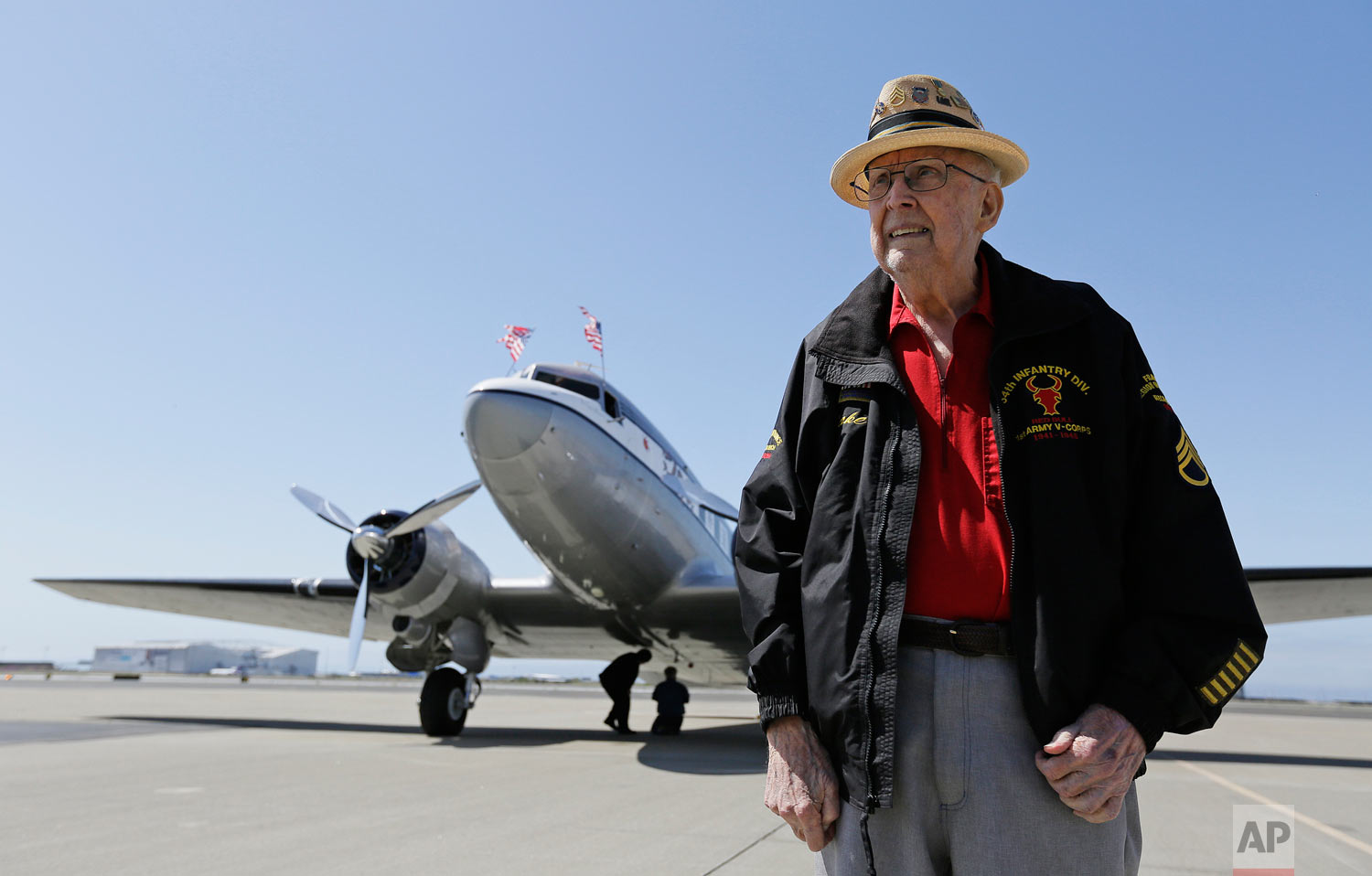 In this photo taken April 29, 2019, D-Day veteran Jake Larson poses before going for a ride in the "The Spirit of Benovia" World War II-era aircraft in Oakland, Calif. Both Larson and the former C-53 Skytrooper transport plane plan to be in Normandy, France and take part in events for the 75th anniversary of D-Day. The plane takes its name after a winery in Sonoma County. (AP Photo/Eric Risberg)