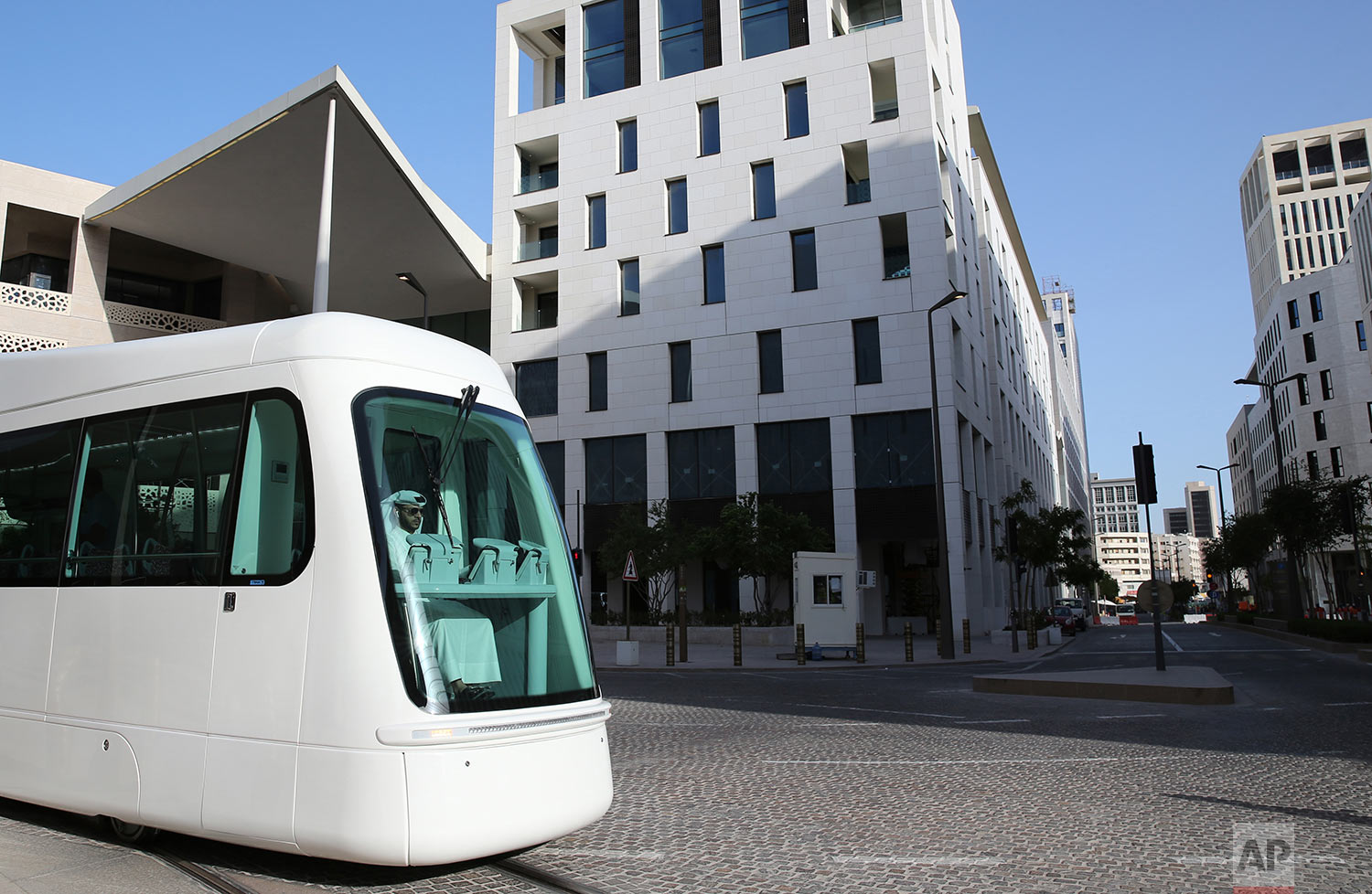  In this Wednesday, April 24, 2019 photo, Mohammed, an Iranian origin Qatari tram driver, born and raised in Qatar, drives during a trial session at the Musheireb Downtown Doha district, Qatar.  (AP Photo/Kamran Jebreili) 