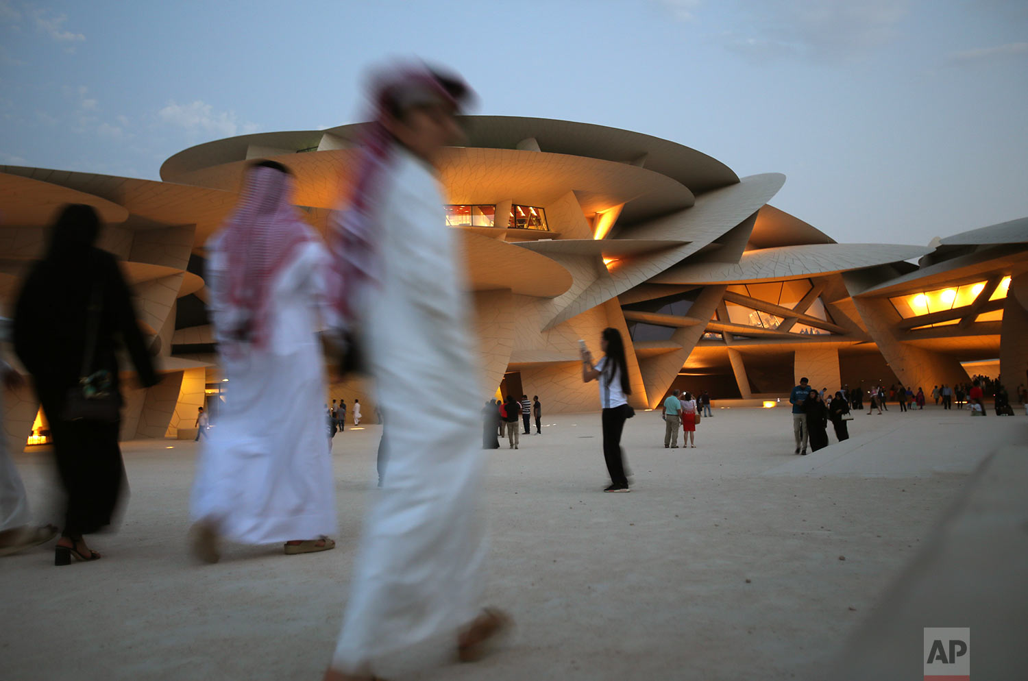  In this Saturday, April 20, 2019 photo, people visit the National Museum of Qatar designed by French architect, Jean Nouvel who got his inspiration from the desert rose crystal and has been opened on March 28th in Doha, Qatar. (AP Photo/Kamran Jebre