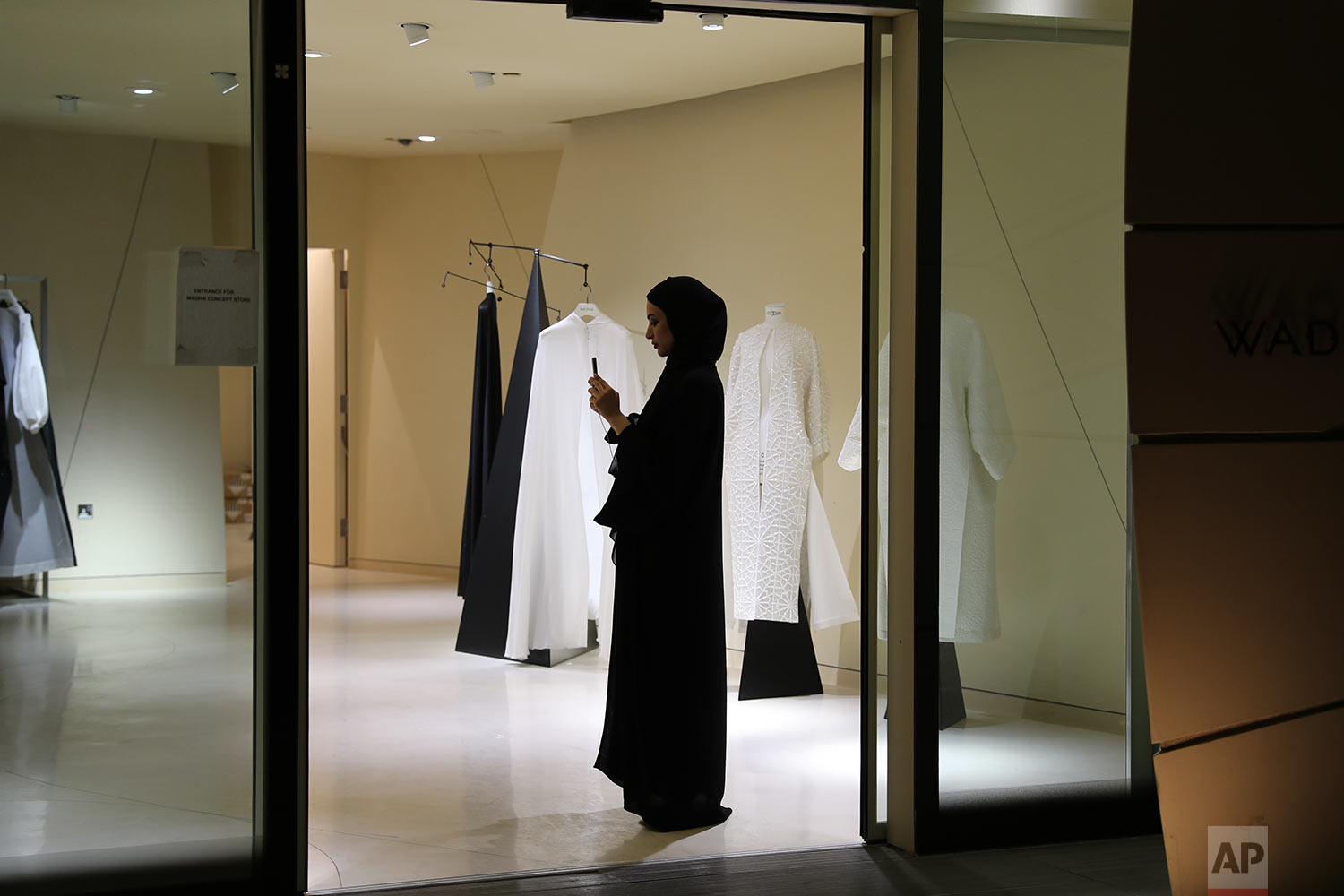  In this Sunday, April 27, 2019 photo, a woman takes photo with her mobile phone at the "Wadha Concept Store" located at the Qatar National Museum venue in Doha, Qatar. (AP Photo/Kamran Jebreili) 