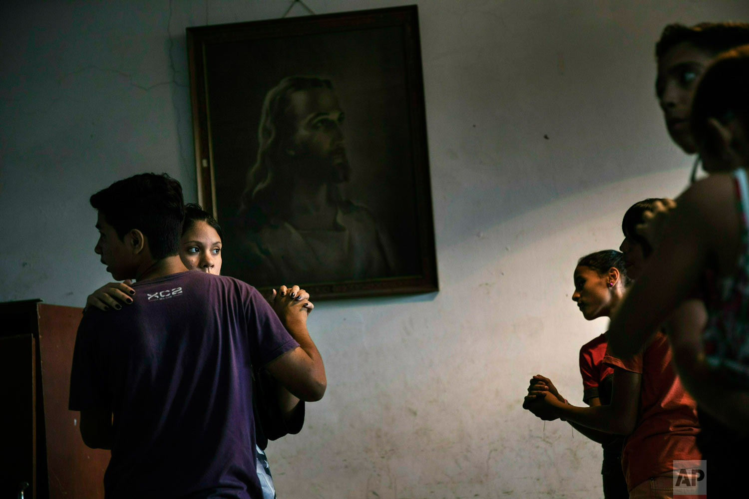 Children participate in a dance class in a parish house in the Petare shanty town, in Caracas, Venezuela, Friday, May 3, 2019. (AP Photo/Rodrigo Abd)