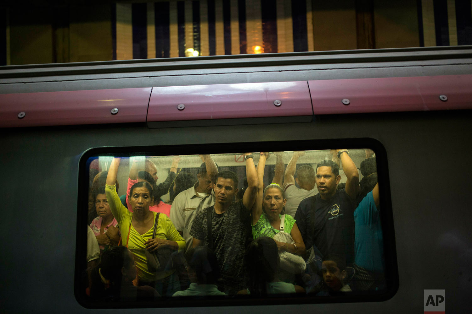 People commute in the subway in Caracas, Venezuela, Friday, May 10, 2019. More than 3 million Venezuelans have left their homeland in recent years amid skyrocketing inflation and shortages of food and medicine. U.S. administration officials have warned that 2 million more are expected to flee by the end of the year if the crisis continues in the oil-rich nation. (AP Photo/Rodrigo Abd)