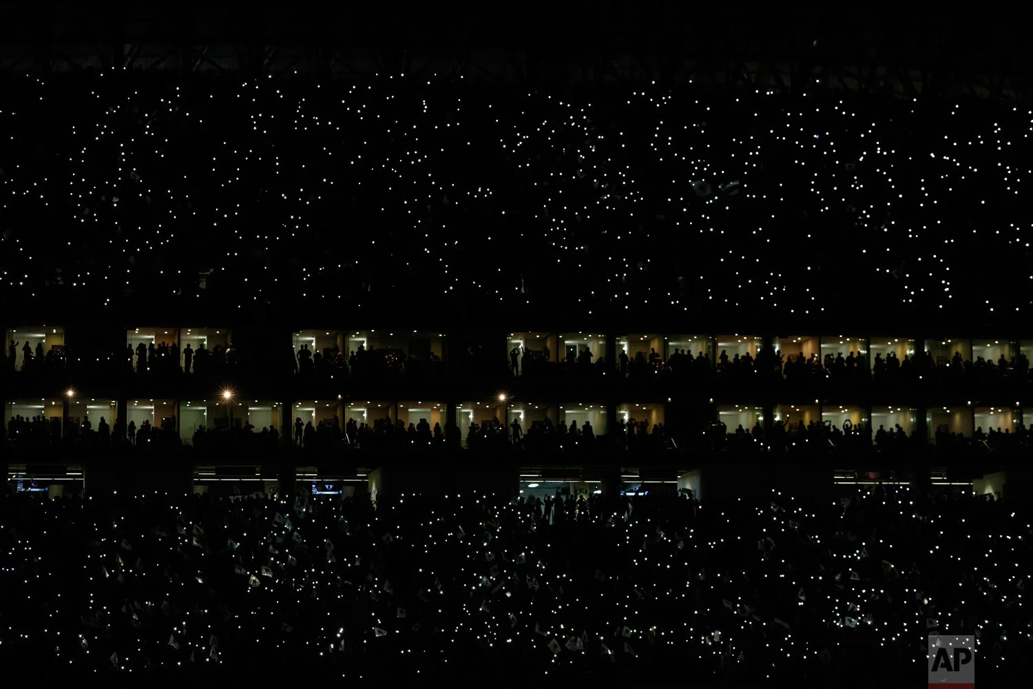 Fans light up their mobile phones prior to the CONCACAF Champions League final soccer match between Monterrey and Tigres in Monterrey, Mexico, Wednesday, May 1, 2019. (AP Photo/Rebecca Blackwell)