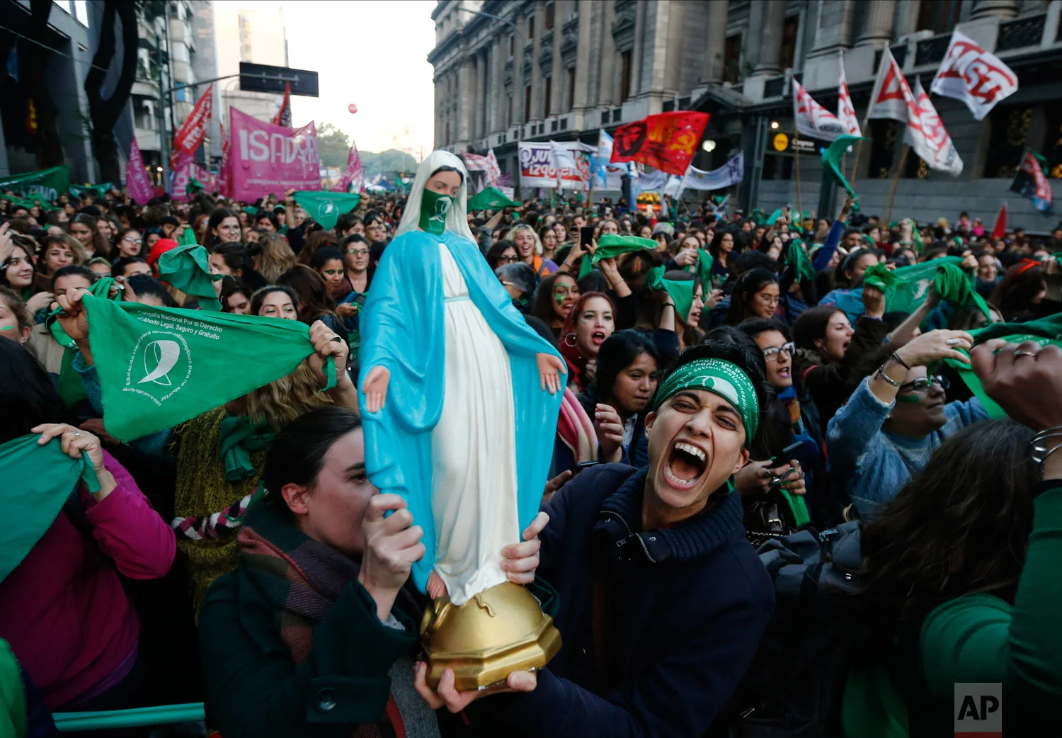 Pro-choice activists carry a statue of the Virgin Mary which features a green handkerchief symbolizing the abortion rights movement in Argentina during a rally outside Congress in favor of legalizing abortion in Buenos Aires, Argentina, Tuesday, May 28, 2019. (AP Photo/Marcos Brindicci)