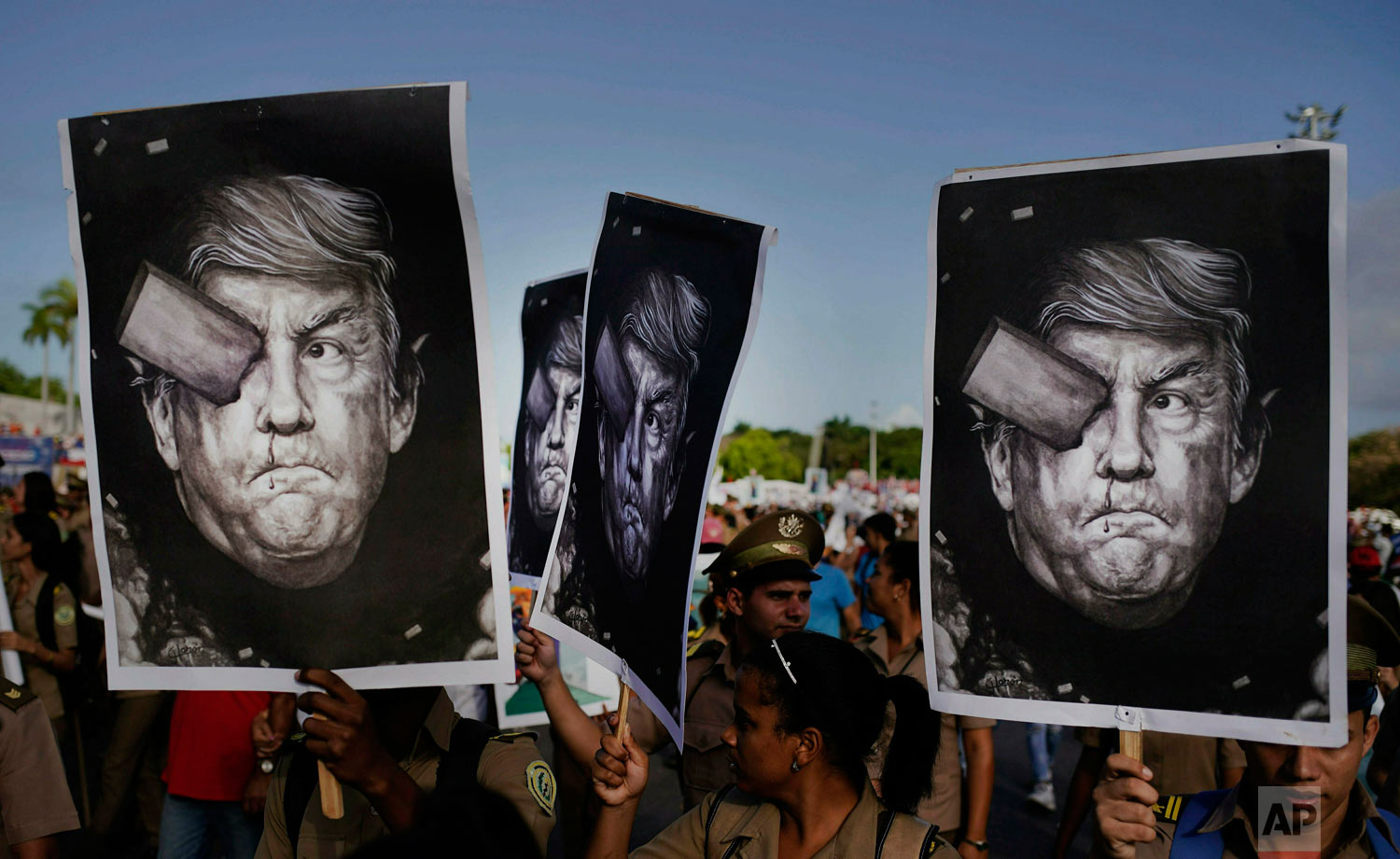  In this May 1, 2019 photo, Cuban soldiers carry depictions of President Donald Trump at the May Day parade in Revolution Square in Havana, Cuba. Trump claimed via Twitter that if Cuban troops and militia do not cease their operations in support of V