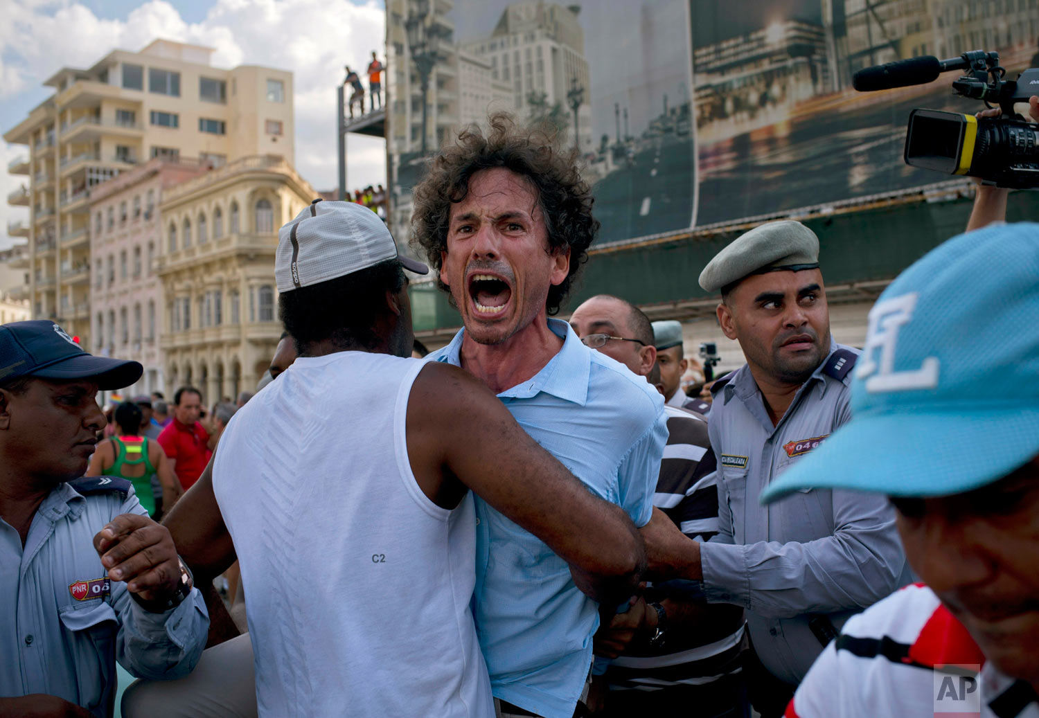 Cuban police detain a gay rights activist during an unauthorized march in H...