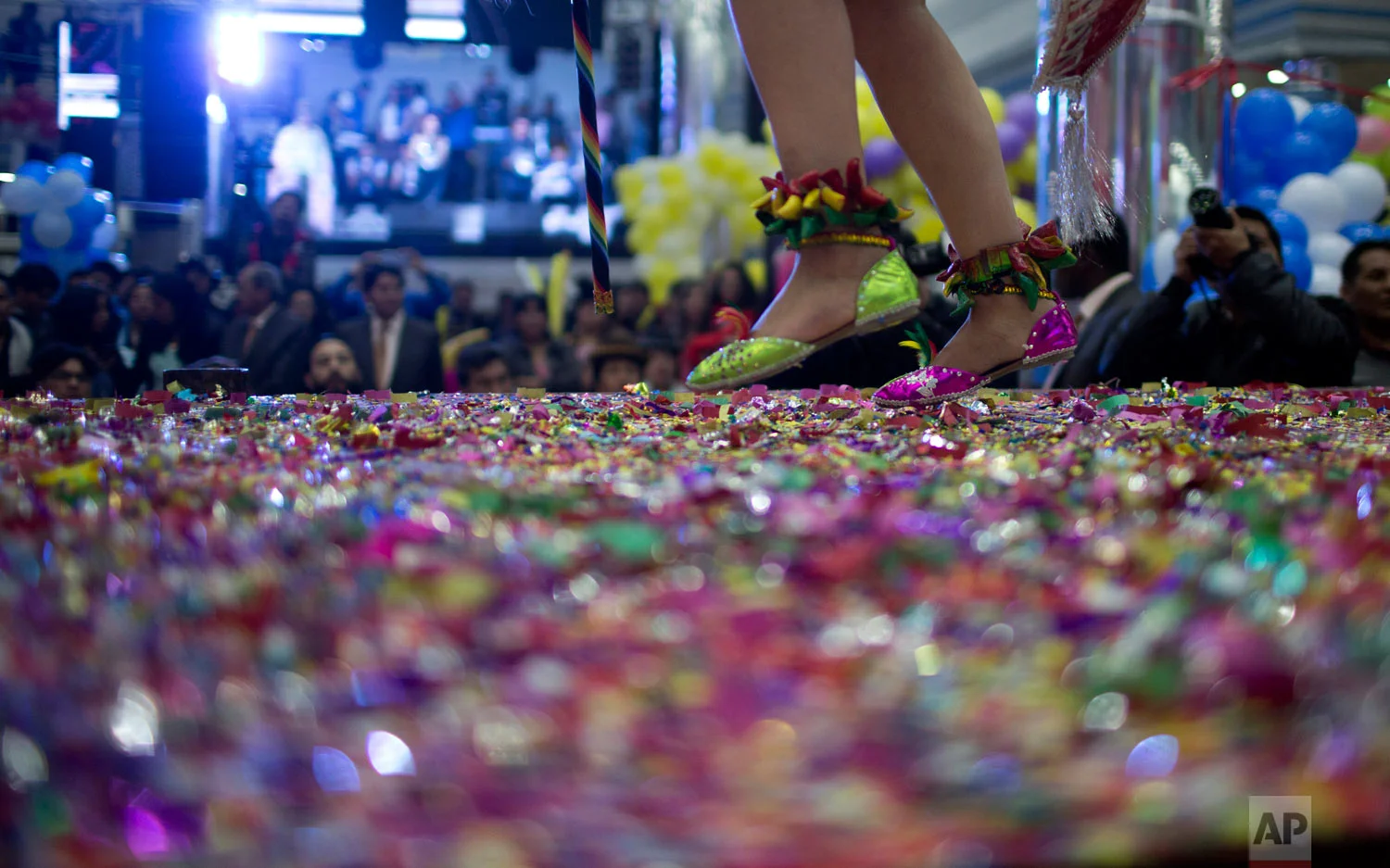 A contestant competes on stage blanketed in confetti in the Queen of Great Power contest in La Paz, Bolivia, Friday, May 24, 2019. The largest religious festival in the Andes choses its queen in a tight contest to head the Festival of the Lord Jesus of the Great Power, mobilizing dancers and musicians. (AP Photo/Juan Karita)