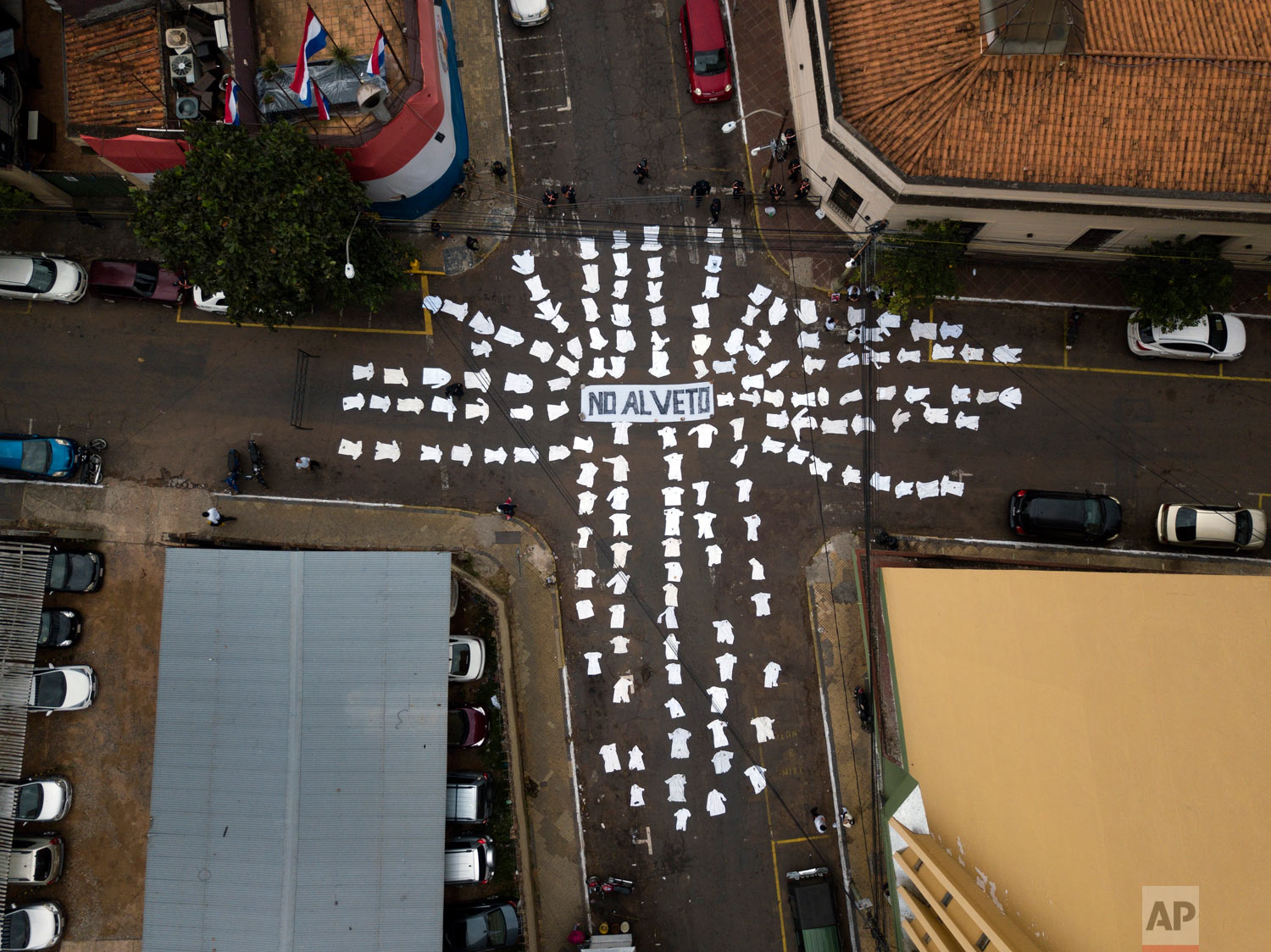  The white coats of doctors lie on the street around the Spanish message "No to the veto," directed at President Mario Abdo Benítez, asking him to not veto a proposed law that would allow doctors to partially retire after 25 years of work in Asuncion