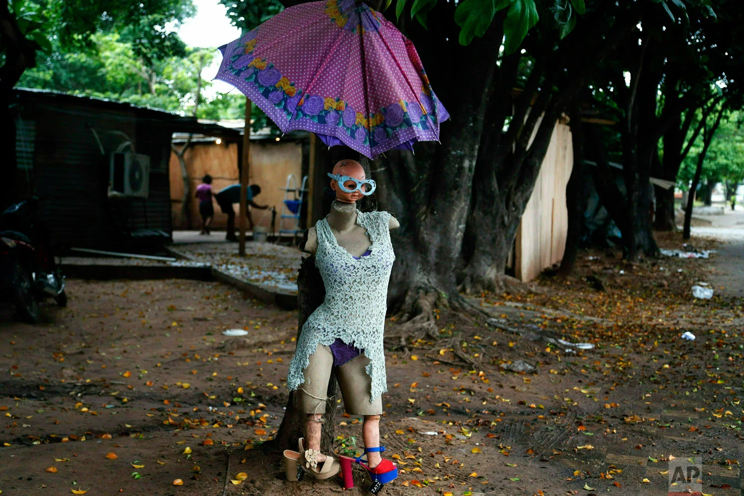 A dressed up mannequin dubbed "Miss Evacuated" placed there by an evacuee stands outside a shelter in Asuncion, Paraguay, Tuesday, May 7, 2019, for people who were forced to evacuate their homes due to flooding caused by heavy rains. (AP Photo/Jorge Saenz)