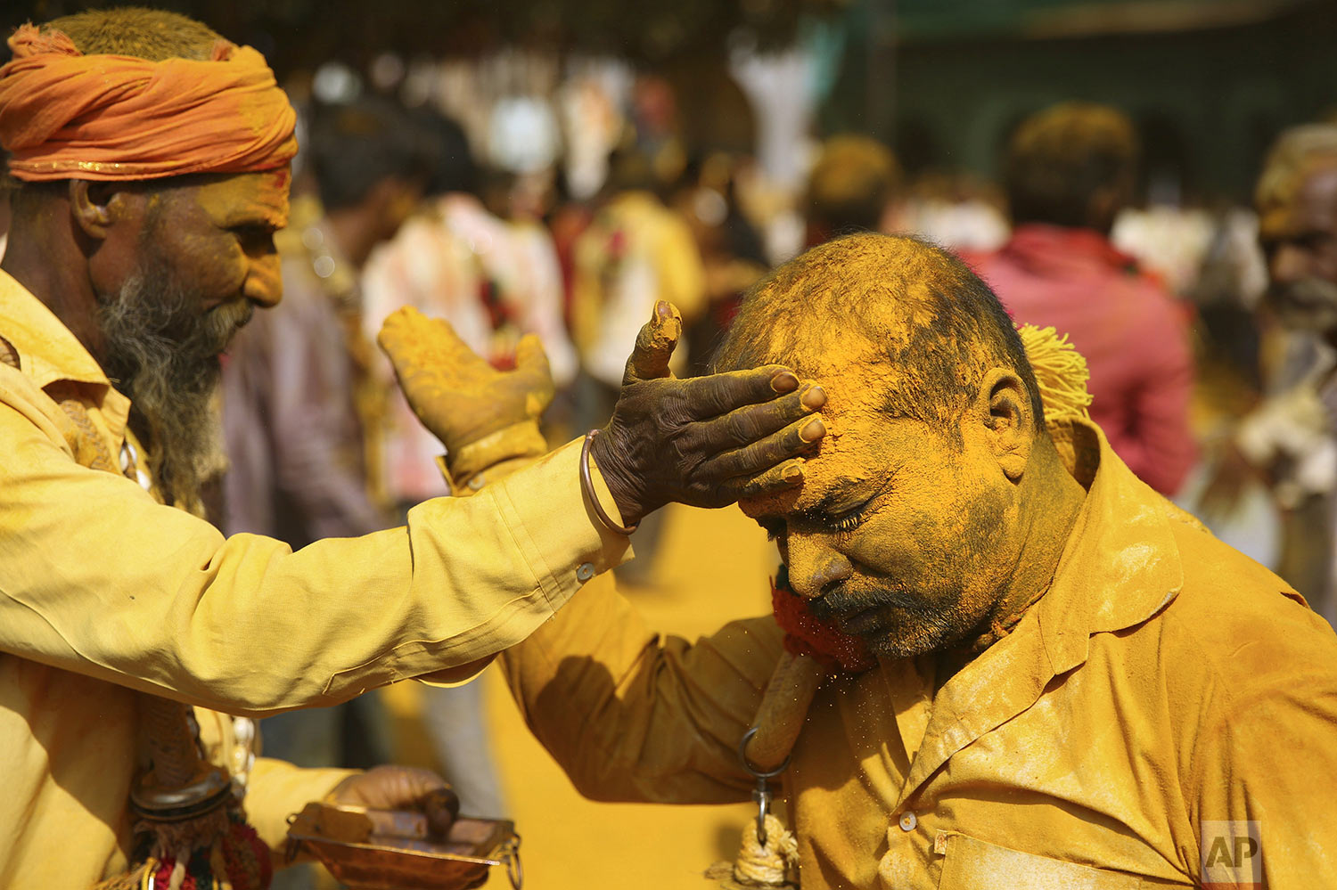 A devotee applies the spice turmeric during the celebration of the Bhandara Festival, or the Festival of Turmeric, at the Jejuri temple in Pune district, Maharashtra state, India, Monday, June 3, 2019. (AP Photo/Rafiq Maqbool)
