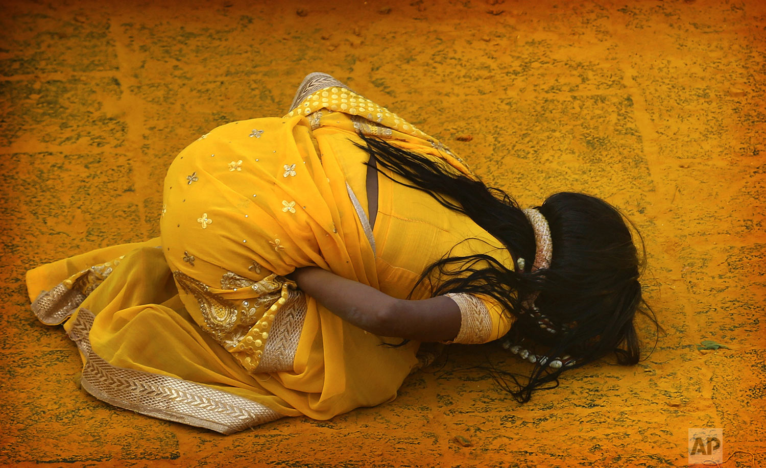 A devotee covered in the spice turmeric goes into a trance during the celebration of the Bhandara Festival, or the Festival of Turmeric, at the Jejuri temple in Pune district, Maharashtra state, India, Monday, June 3, 2019. (AP Photo/Rafiq Maqbool)