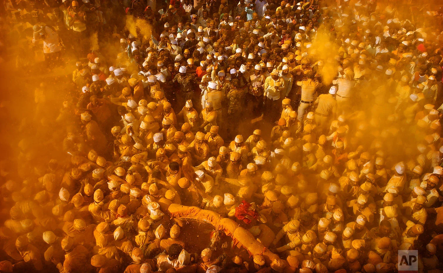 Devotees smeared in turmeric join a procession during the celebration of the Bhandara Festival, or the Festival of Turmeric, at the Jejuri temple in Pune district, Maharashtra state, India, Monday, June 3, 2019. (AP Photo/Rafiq Maqbool)