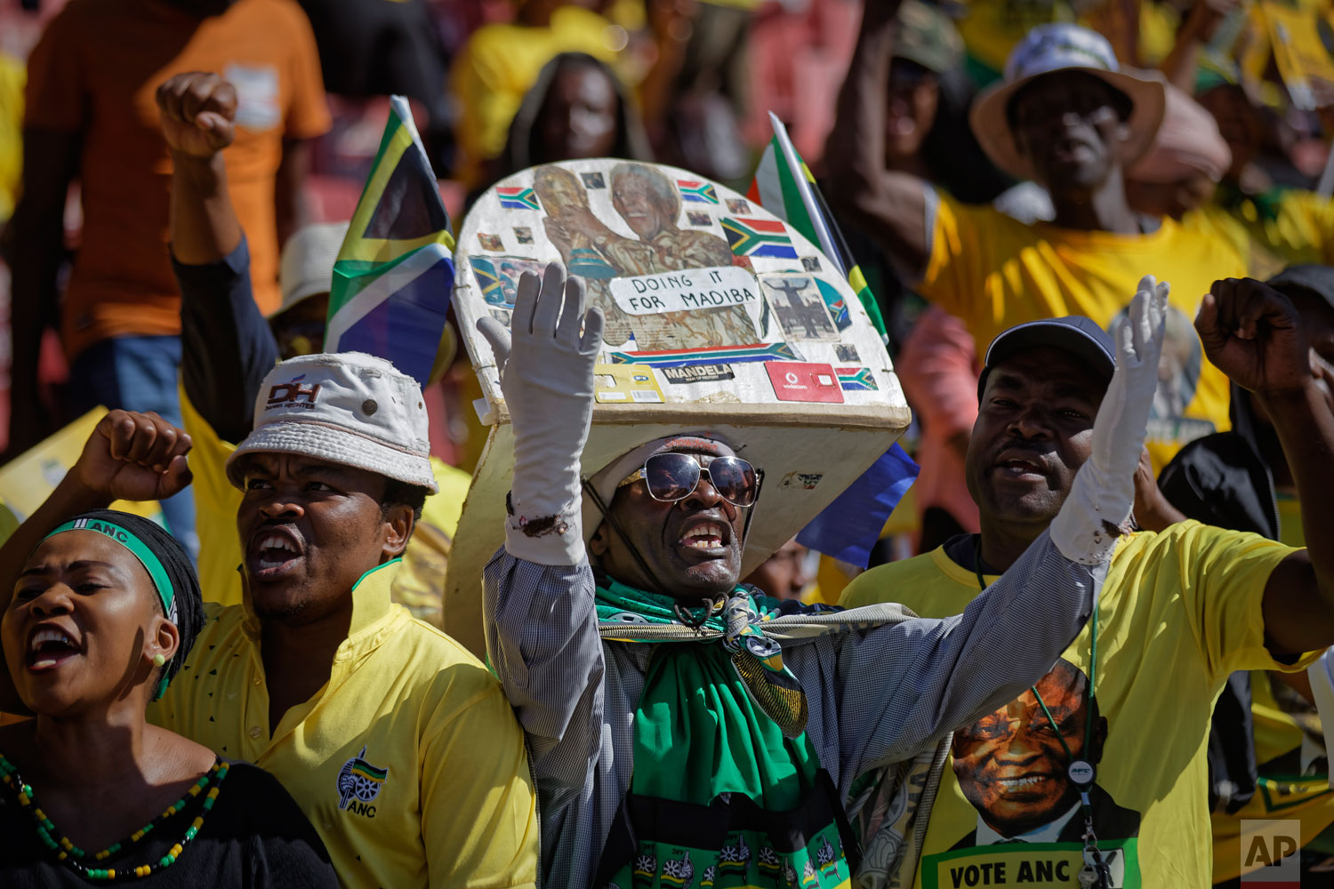 A supporter of the ruling African National Congress (ANC) wears a hat referring to former President Nelson Mandela by his nickname "Madiba", at the party's final election rally at Ellis Park stadium in Johannesburg, South Africa Sunday, May 5, 2019. (AP Photo/Ben Curtis)