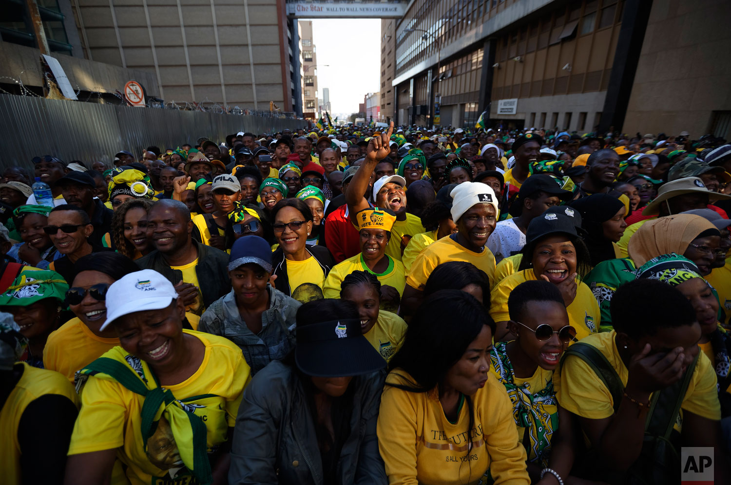 Supporters of the African National Congress (ANC) party cheer during a victory rally in downtown Johannesburg, South Africa Sunday, May 12, 2019. (AP Photo/Ben Curtis)