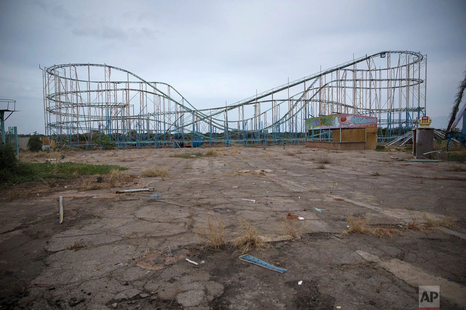 A roller coaster stands tall in the abandoned amusement park coined "Diversions Grano de Oro" in Maracaibo, Venezuela, May 23, 2019. (AP Photo/Rodrigo Abd)