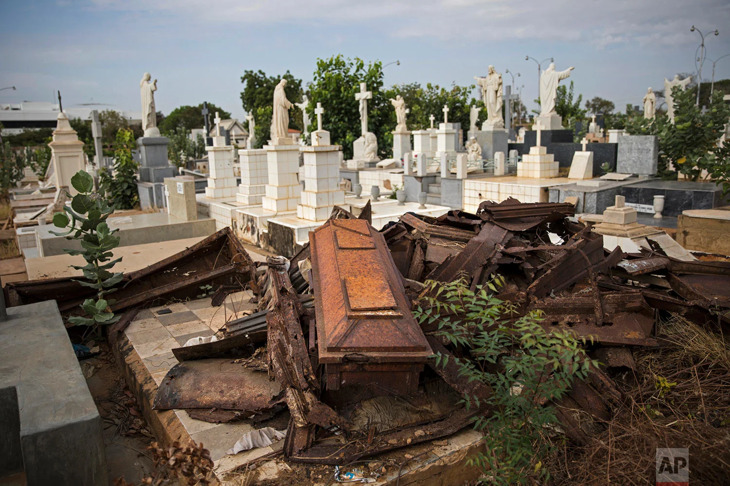 Looted coffins lay in a pile after grave robbers moved through El Cuadrado cemetery in Maracaibo, Venezuela, May 16, 2019. Daily burials used to happen until late afternoon, but the cemetery has tightened up on security, only holding burials until noon to deter grave robbers. (AP Photo/Rodrigo Abd)