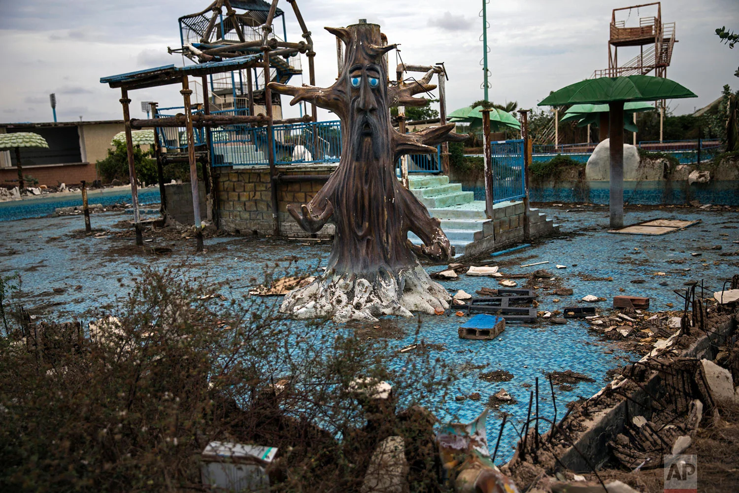 A theme-pool lays in ruins at an abandoned amusement park coined "Diversions Grano de Oro" in Maracaibo, Venezuela, May 23, 2019. (AP Photo/Rodrigo Abd)