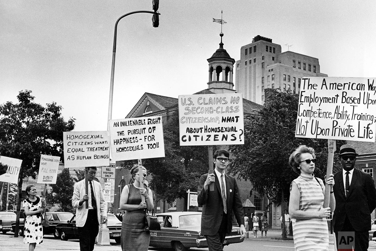 In this July 4, 1967 file photo Kay Tobin Lahusen, right, and other demonstrators carry signs calling for protection of homosexuals from discrimination as they march in a picket line in front of Independence Hall in Philadelphia. In 2019, same-sex marriage is the law of the land in the U.S. and at least 25 other countries. LGBT Americans serve as governors, big-city mayors and members of Congress, and one _ Pete Buttigieg _ is waging a spirited campaign for president. (AP Photo/John F. Urwiller)