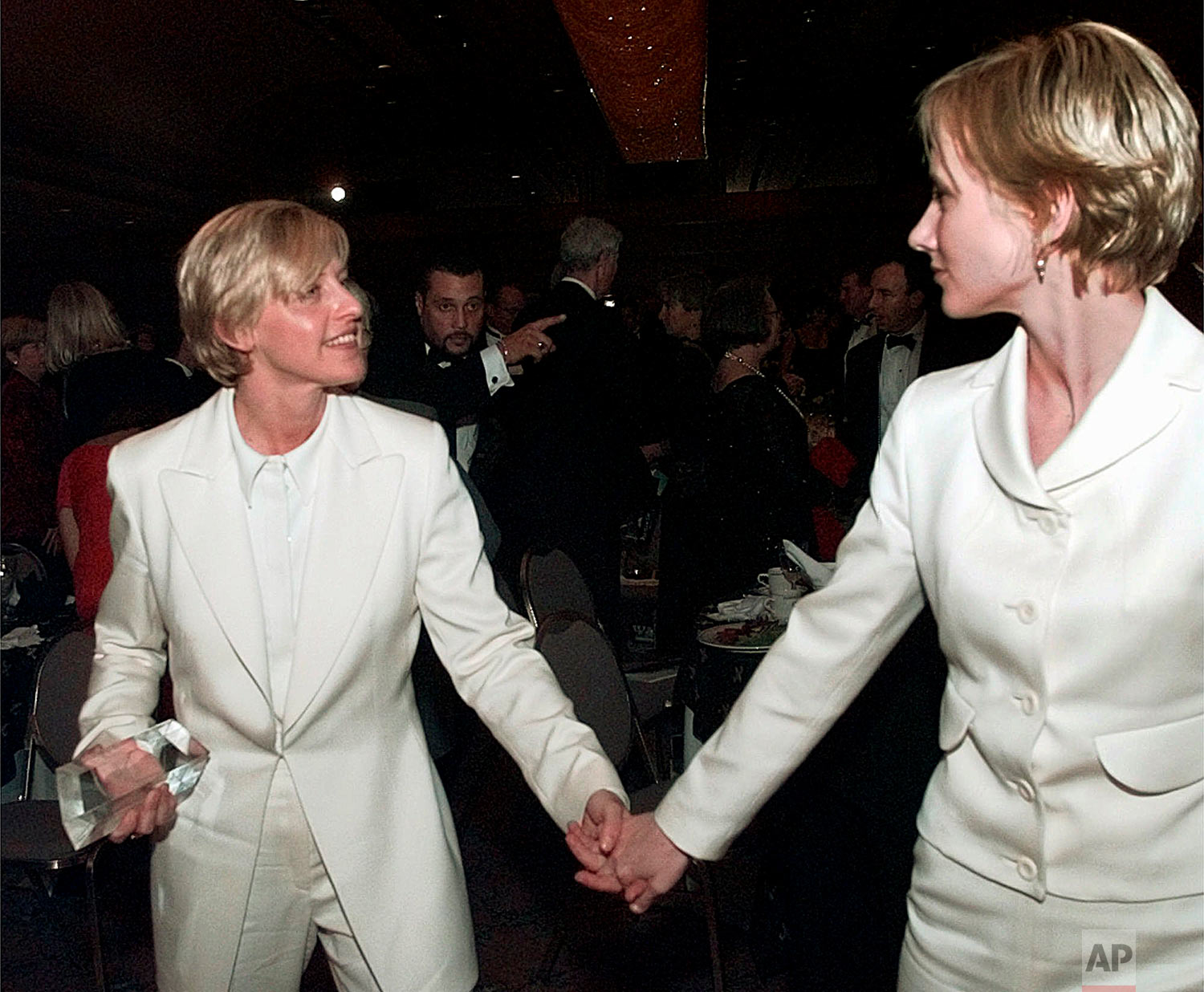 In this Saturday, Nov. 8, 1997 file photo, actress Ellen DeGeneres, left, and her companion, Anne Heche, leave the Human Rights Campaign national dinner in Washington after DeGeneres received her civil rights award. President Clinton spoke earlier at the dinner, before the nation's largest lesbian and male homosexual group--the first president to appear before such an audience. (AP Photo/Brian K. Diggs)