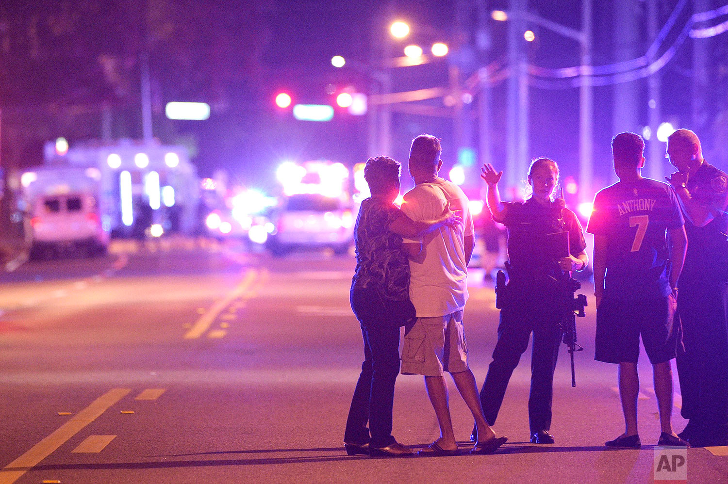 In this Sunday, June 12, 2016 file photo, police officers direct family members away from a fatal shooting at Pulse Orlando nightclub in Orlando, Fla. A gunman massacred 49 people and wounded many others at the gay nightclub. (AP Photo/Phelan M. Ebenhack)