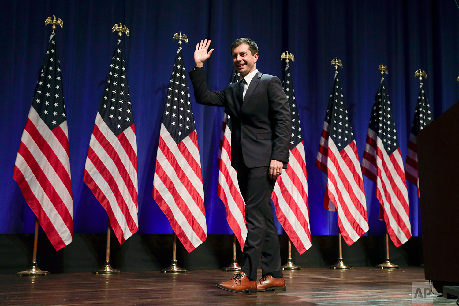 In this Tuesday, June 11, 2019 file photo, Democratic presidential candidate Mayor Pete Buttigieg waves at Indiana University Auditorium in Bloomington, Ind., to speak on foreign policy and national security. (AP Photo/Michael Conroy)