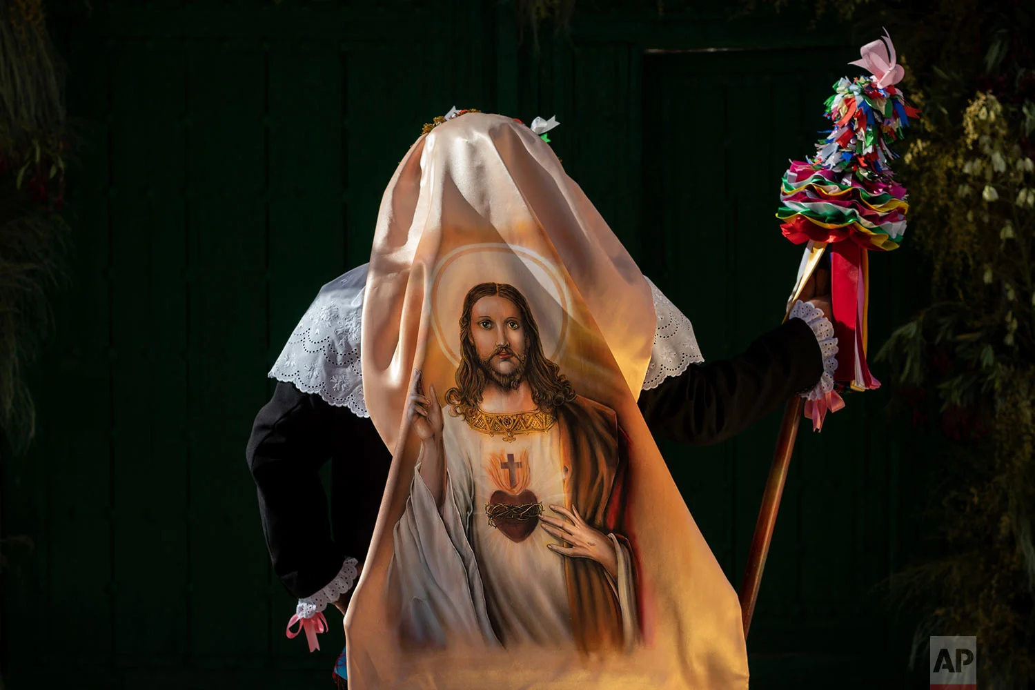 In this Thursday, June 20, 2019 photo, portrait of a member of the "Hermandad del santísimo sacramento pecados y danzantes" brotherhood in Camunas, central Spain. (AP Photo/Bernat Armangue)