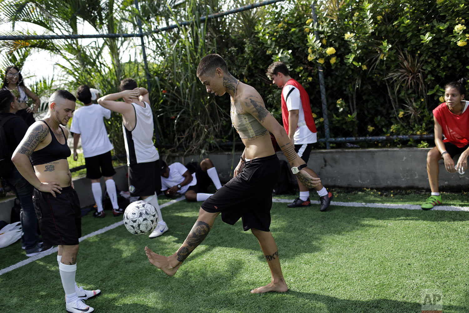 Caua Fraga kicks the ball during a practice session with the Bigtboys transgender men's soccer team in Rio de Janeiro, Brazil, May 13, 2019. The rise of Brazilian President Jair Bolsonaro and a socially conservative wave has alarmed the LGBT community, including the Bigtboys. (AP Photo/Silvia Izquierdo)