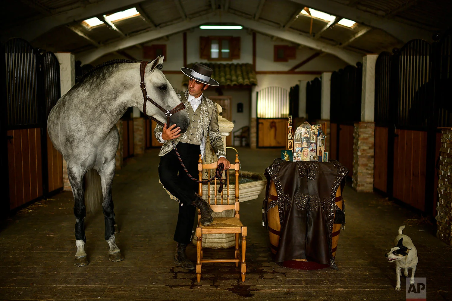 Roberto Armendariz poses with one of his horses known as Heroi, at his ranch in Noain, northern Spain, June 28, 2019. (AP Photo/Alvaro Barrientos)
