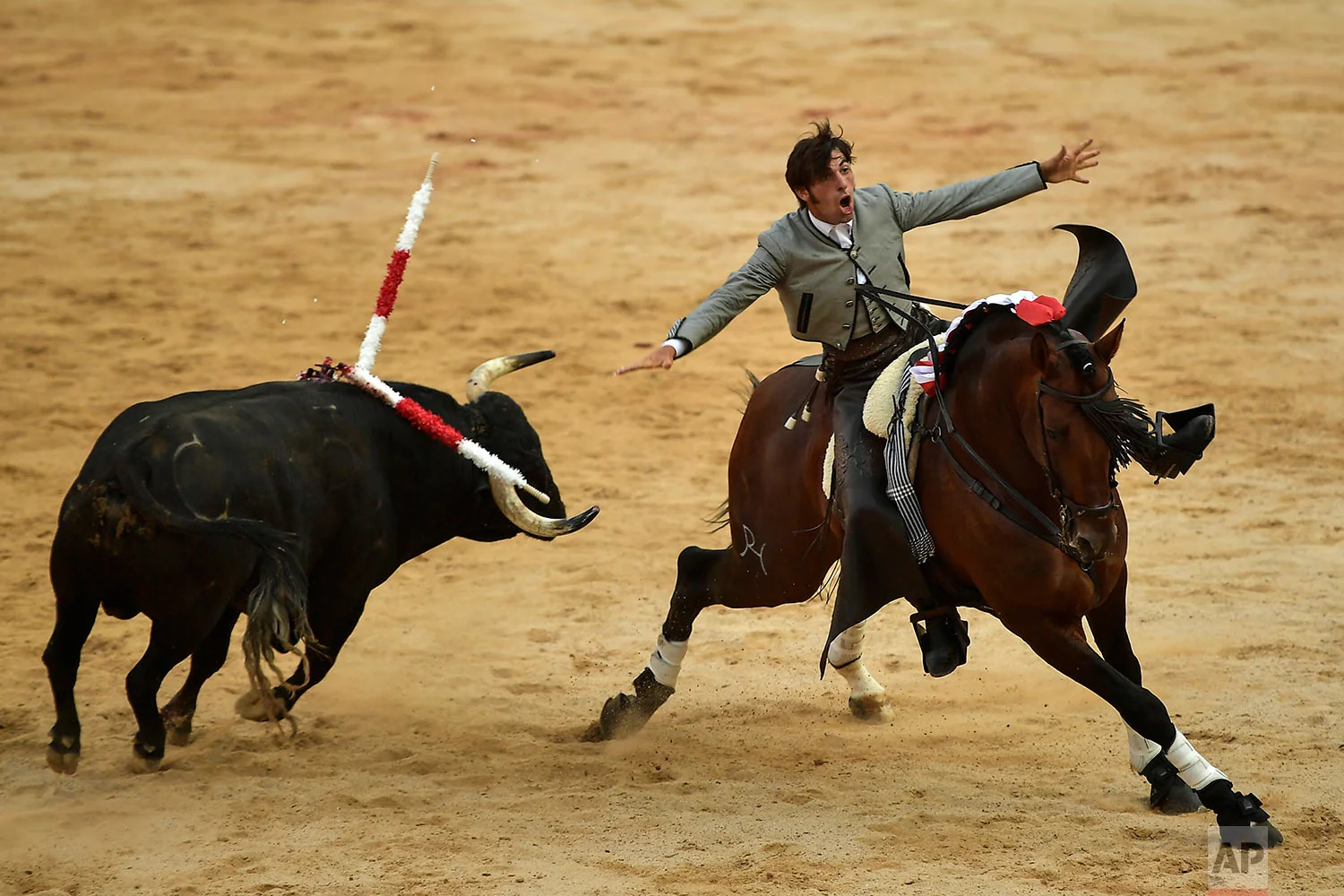 Roberto Armendariz, 33, Spanish ''rejoneador'' or mounted bullfighter, waves at the end of his performance during a horseback bullfight at San Fermin Fiestas, northern Spain, July 6, 2019. (AP Photo/Alvaro Barrientos)