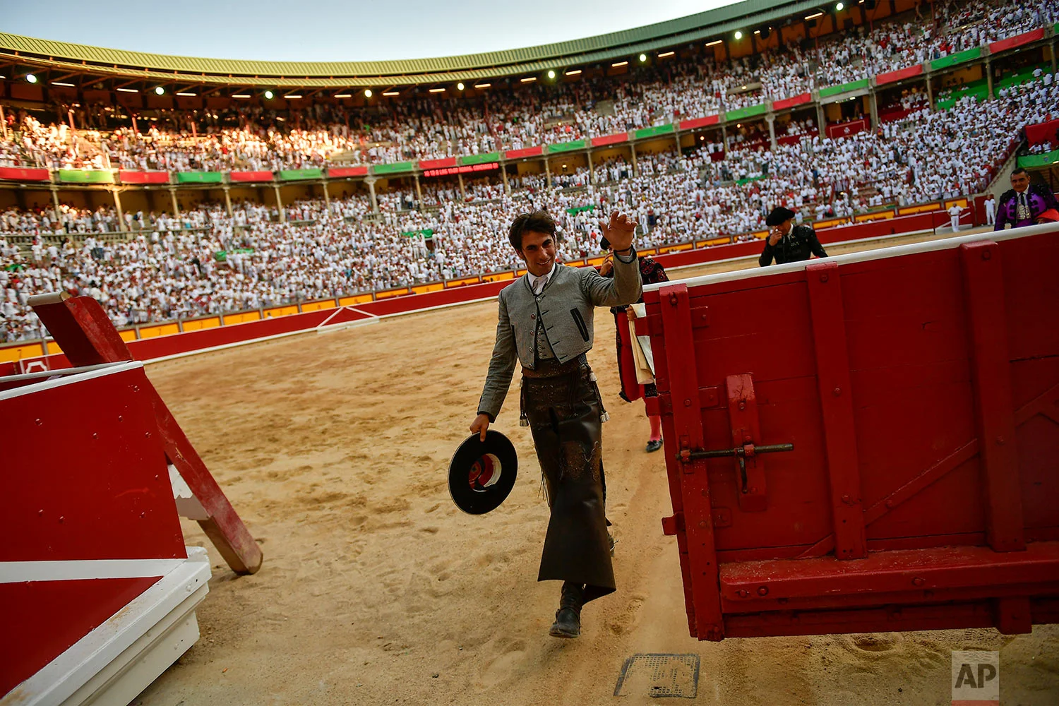 Roberto Armendariz, 33, Spanish ''rejoneador'' or mounted bullfighter, waves at the end of his performance during a horseback bullfight at San Fermin Fiestas, northern Spain, July 6, 2019. (AP Photo/Alvaro Barrientos)