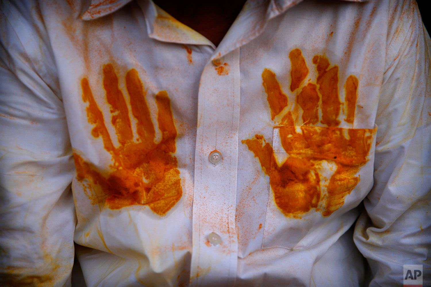 A devotee's shirt has handprints of the spice turmeric during the celebration of the Bhandara Festival, or the Festival of Turmeric, at the Jejuri temple in Pune district, Maharashtra state, India. During the festival, devotees use the golden powder to worship the deity Lord Khandoba, widely known as a descendant of the sun, and to celebrate his victory over the demons Mani and Malla. (AP Photo/Rafiq Maqbool)