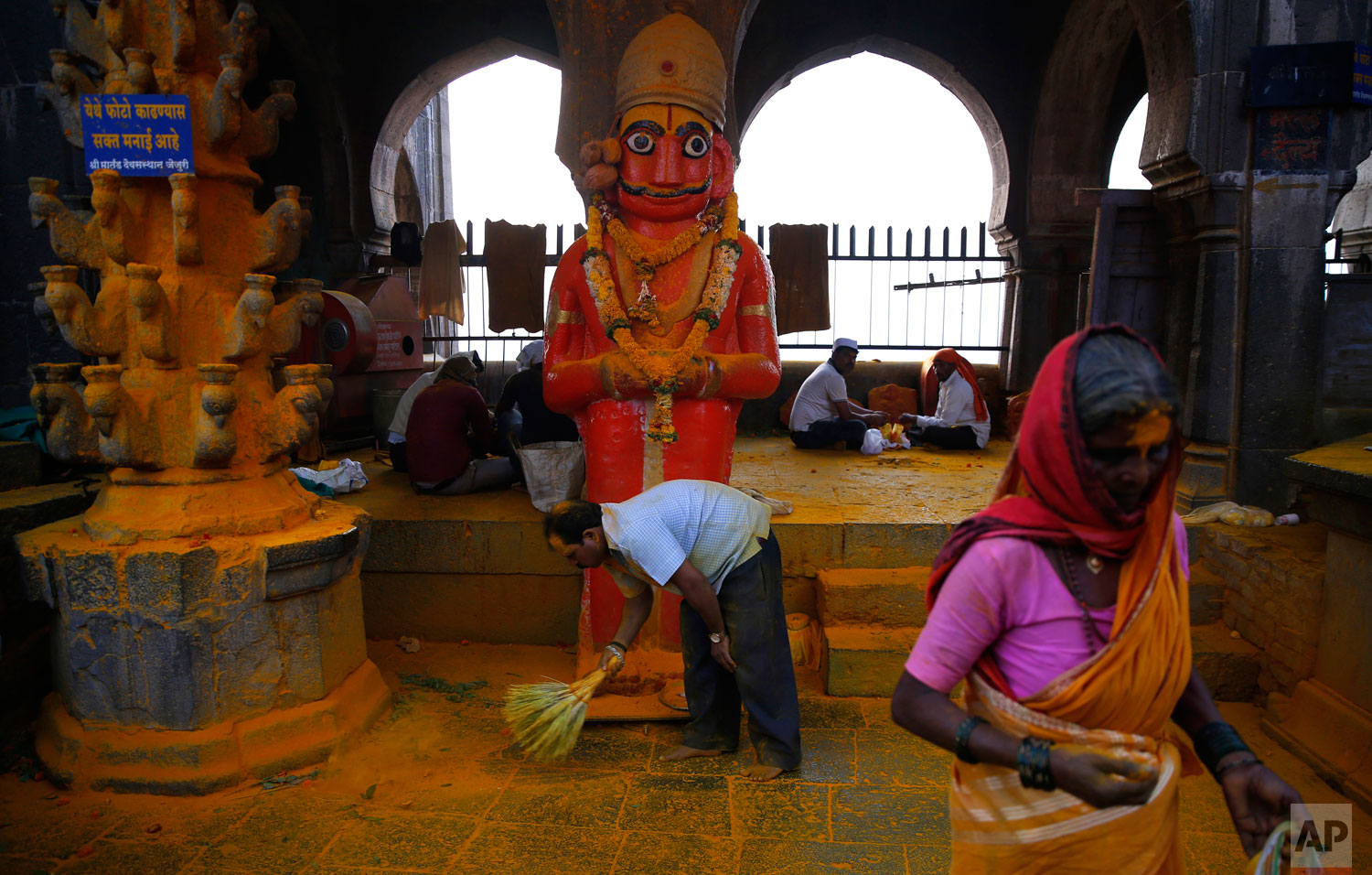 A devotees sweeps before the celebration of the Bhandara Festival, or the Festival of Turmeric, at the Jejuri temple in Pune district, Maharashtra state, India. During the festival, devotees use the golden powder to worship the deity Lord Khandoba, widely known as a descendant of the sun, and to celebrate his victory over the demons Mani and Malla. (AP Photo/Rafiq Maqbool)