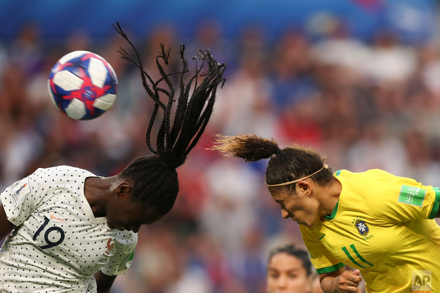 France's Griedge Mbock Bathy, left, and Brazil's Cristiane go for a header during the Women's World Cup round of 16 soccer match between France and Brazil at the Oceane stadium in Le Havre, France, Sunday, June 23, 2019. (AP Photo/Francisco Seco)