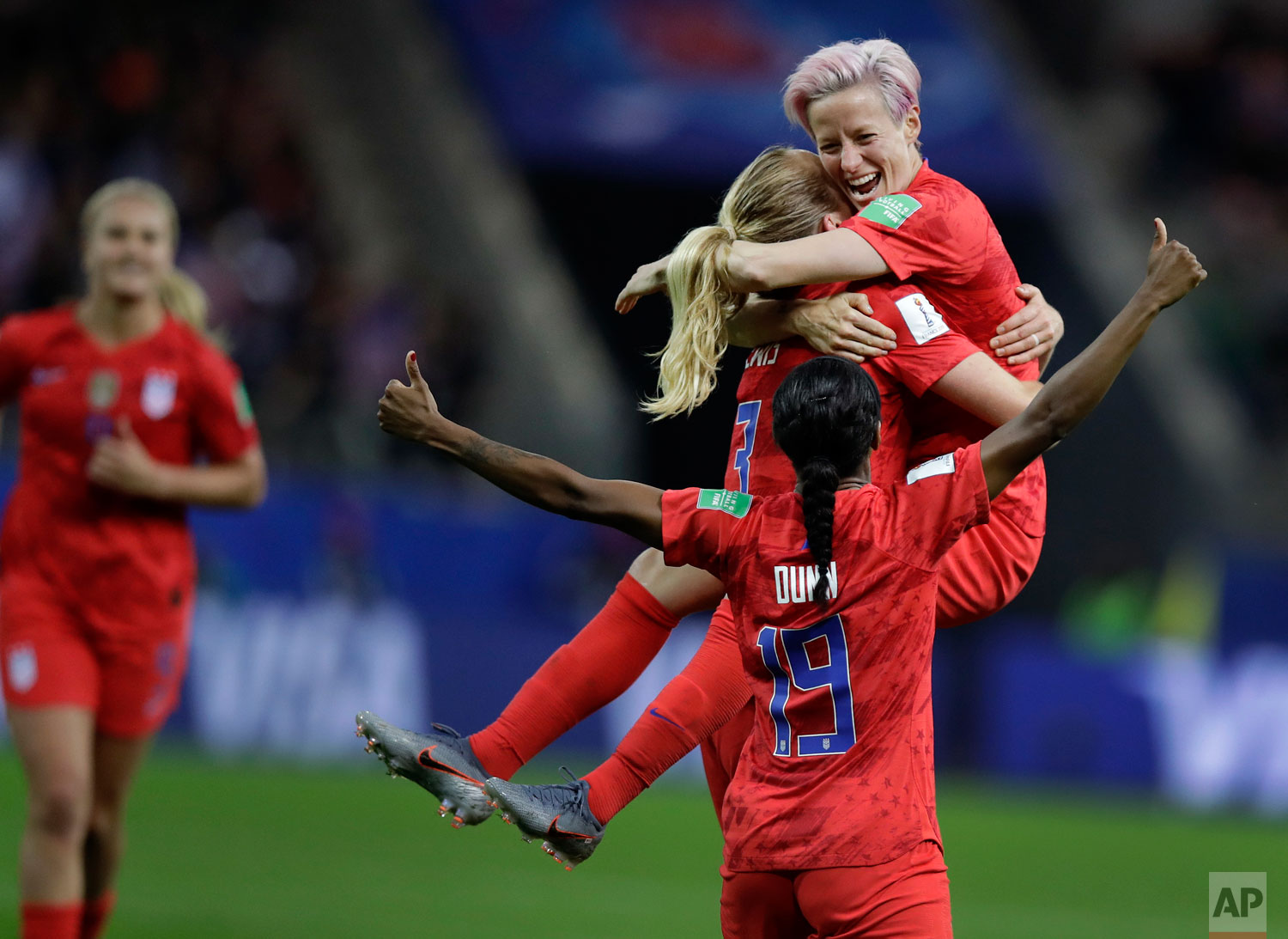 United States' scorer Samantha Mewis lifts her teammate Megan Rapinoe as she celebrates her side's 4rth goal during the Women's World Cup Group F soccer match between United States and Thailand at the Stade Auguste-Delaune in Reims, France, Tuesday, June 11, 2019. (AP Photo/Alessandra Tarantino)