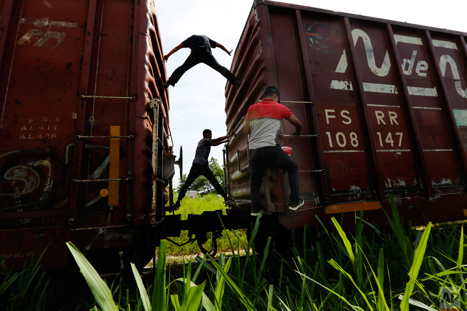 Honduran migrants ride a freight train on their way north, in Salto del Agua, Chiapas state, Mexico, Tuesday, June 25, 2019. (AP Photo/Marco Ugarte)