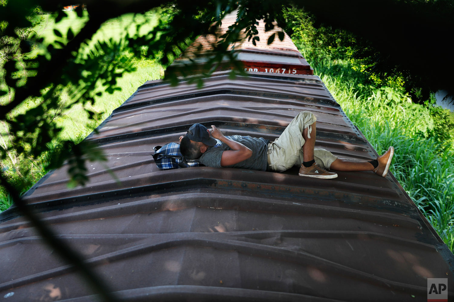 A Honduran migrant ride a freight train on their way north, in Salto del Agua, Chiapas state, Mexico, Tuesday, June 25, 2019. (AP Photo/Marco Ugarte)