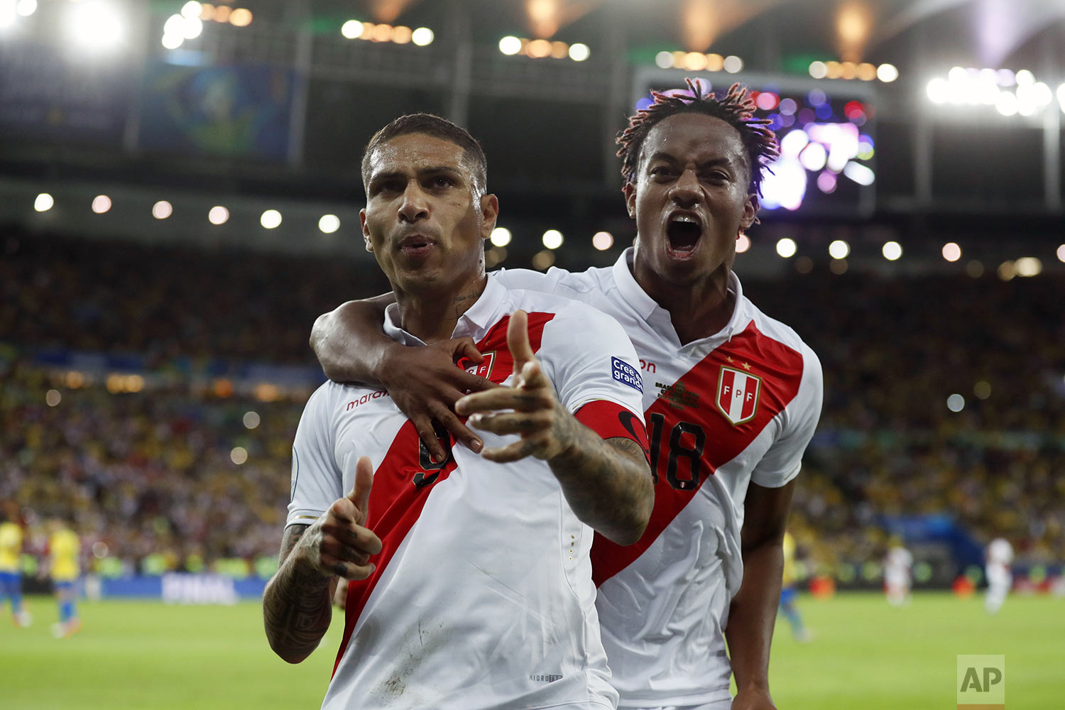  Peru's Paolo Guerrero, left, celebrates with teammate Andre Carrillo, after scoring a penalty kick against Brazil during the final soccer match of the Copa America at Maracana stadium in Rio de Janeiro, Brazil, Sunday, July 7, 2019. (AP Photo/Victor